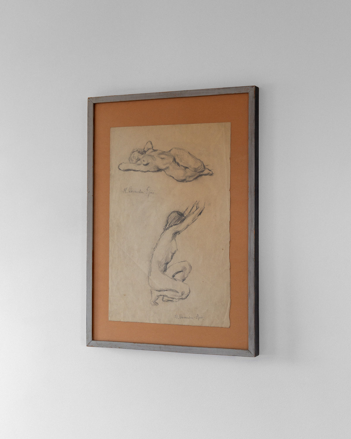 The white wall is adorned with framed artwork, showcasing "Nude Drawing Study I, 1940s" by Spigel. These exquisite sketches feature a reclining and kneeling figure, capturing the female form as signed by the talented artist Harriet Rosander de Tourtchaninoff.