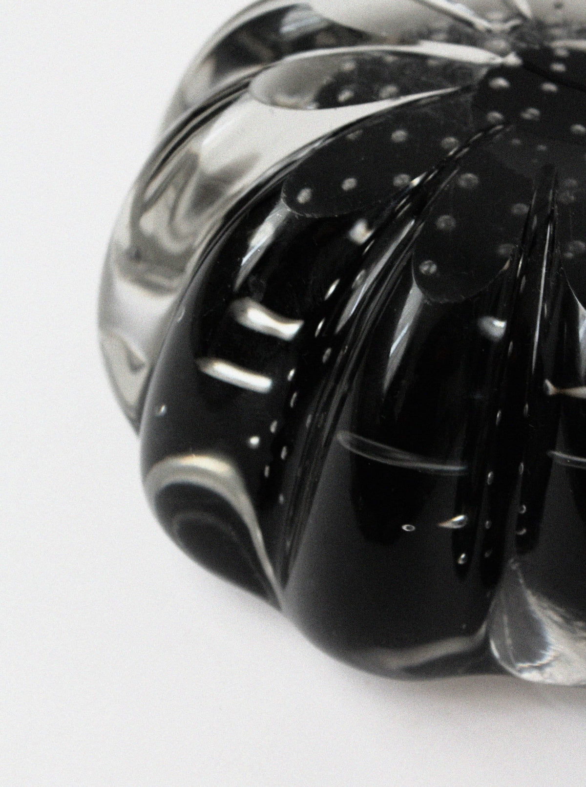 Close-up detail of Walter Johansson crystal glass ashtray showing curved form