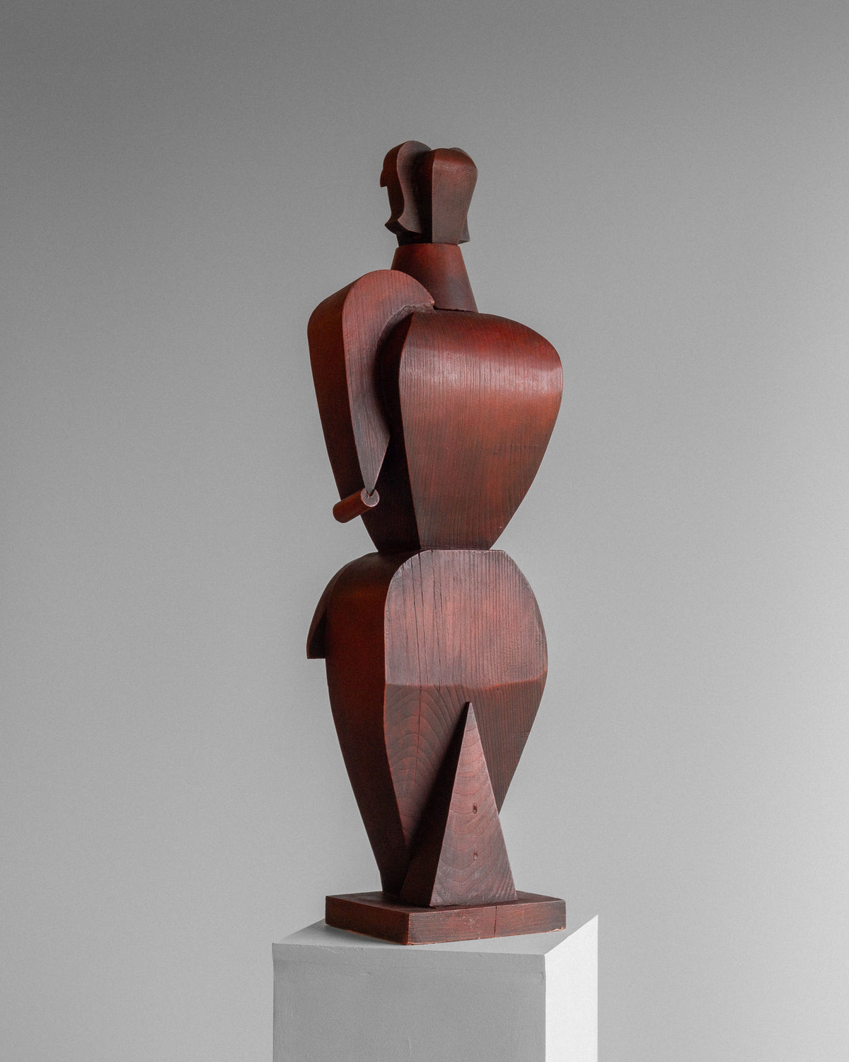 The Vintage Cubist Sculpture II by Atelier Boulogne, from Spigel, features a geometric wooden female figure with angular shapes and curves on a pedestal. The abstract cubist design suggests a torso and limbs against a plain gradient backdrop.