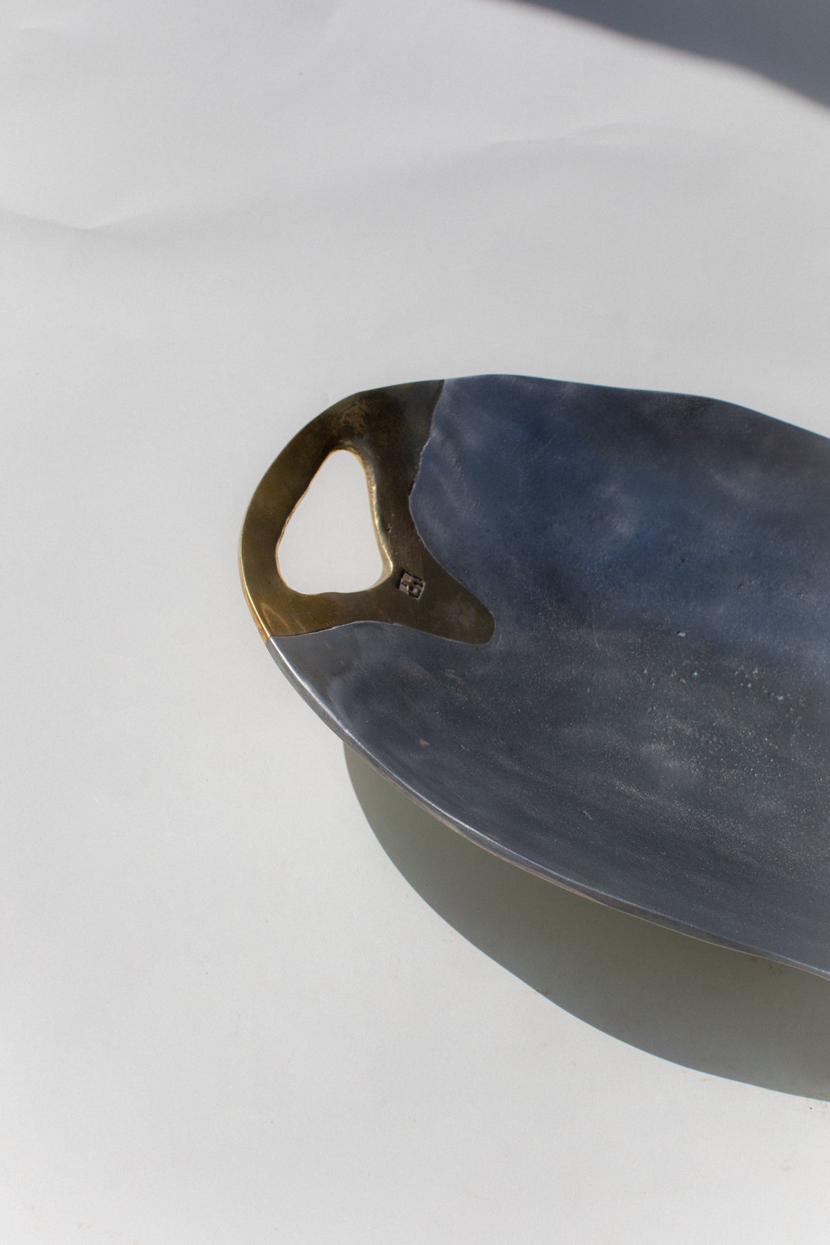 Dark ceramic brutalist bowl with sculptural handle detail view