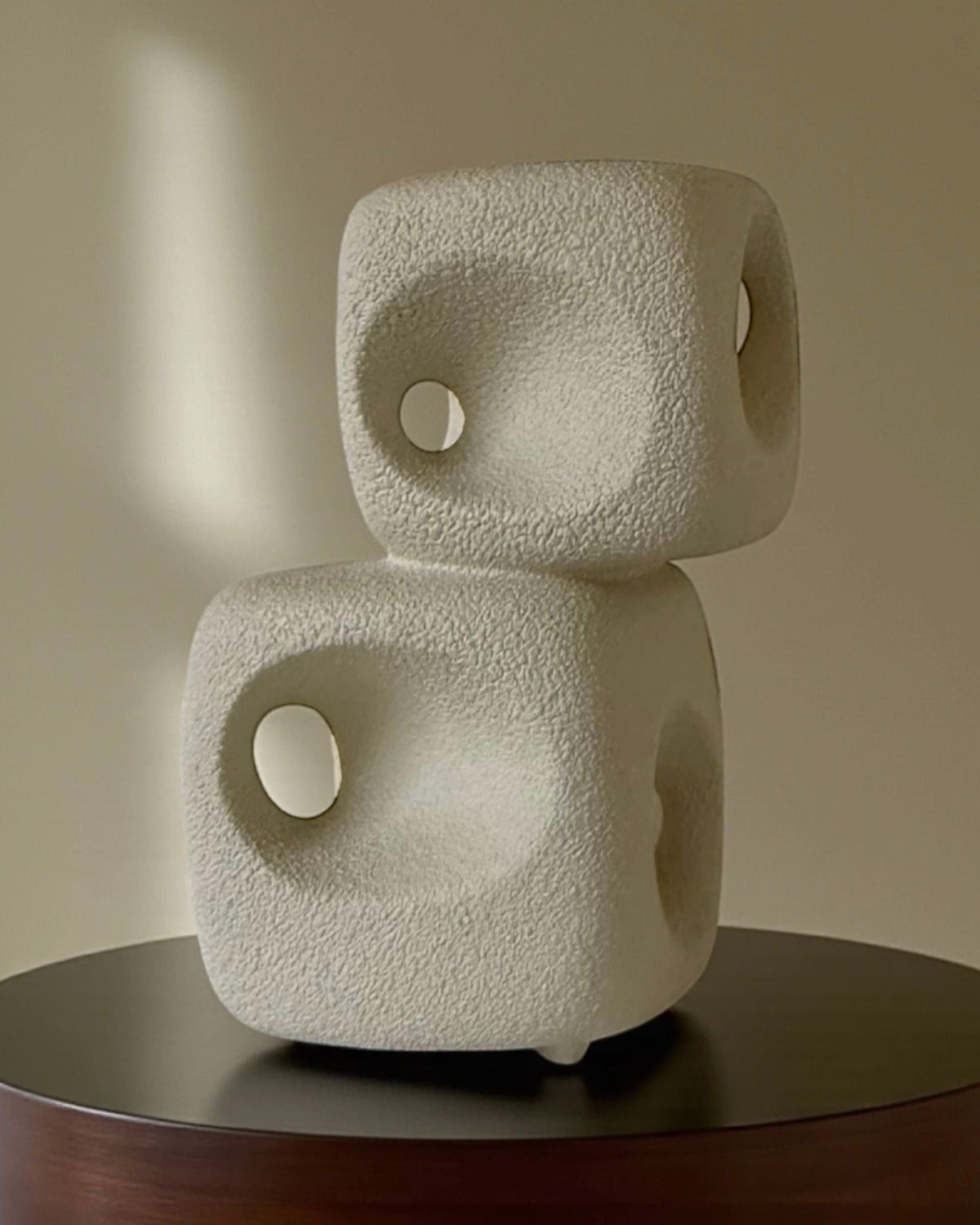 Two stacked cream ceramic dice vases with circular holes by Bertoncello