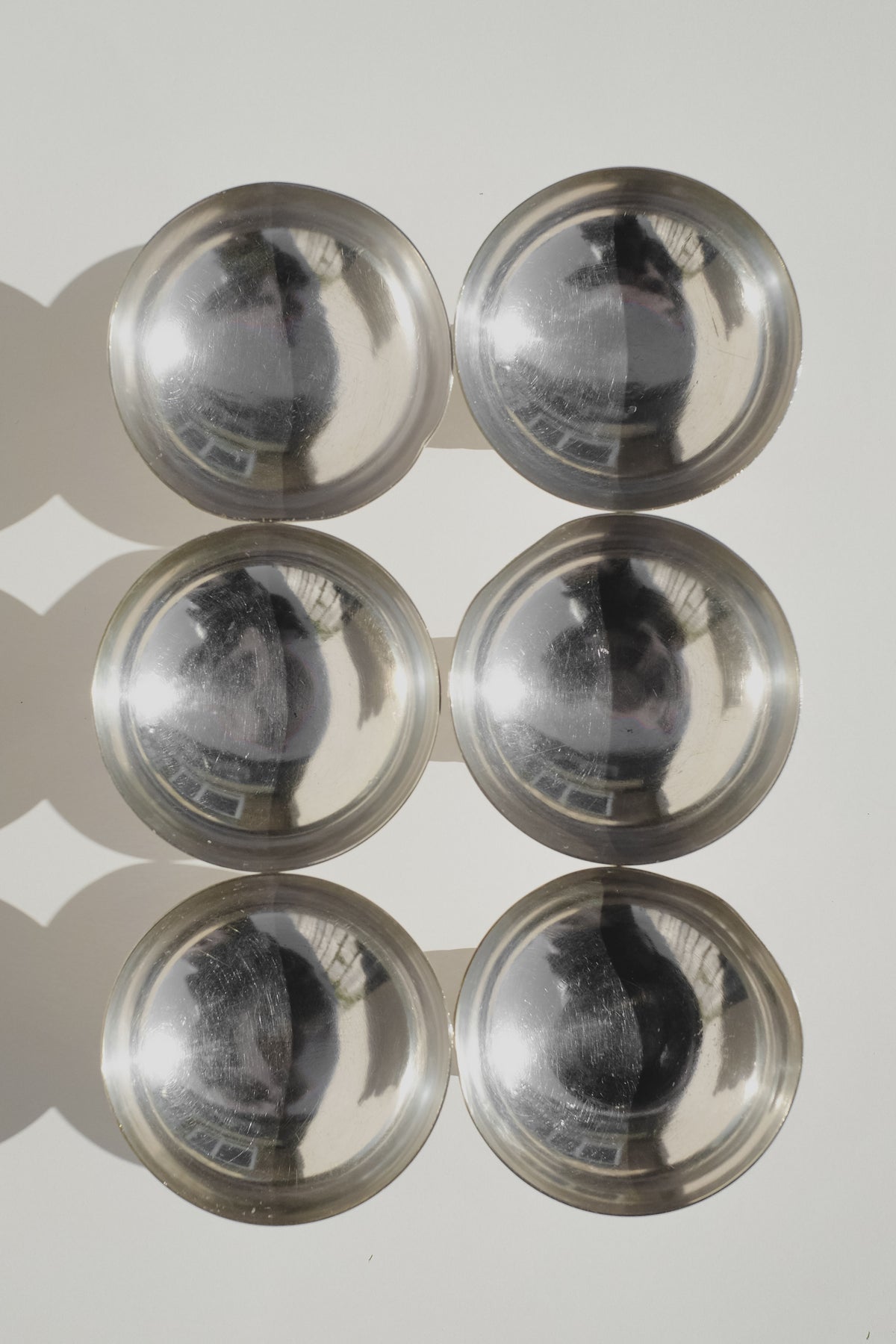 Six metallic ice coupes arranged in grid formation showing reflective silver finish