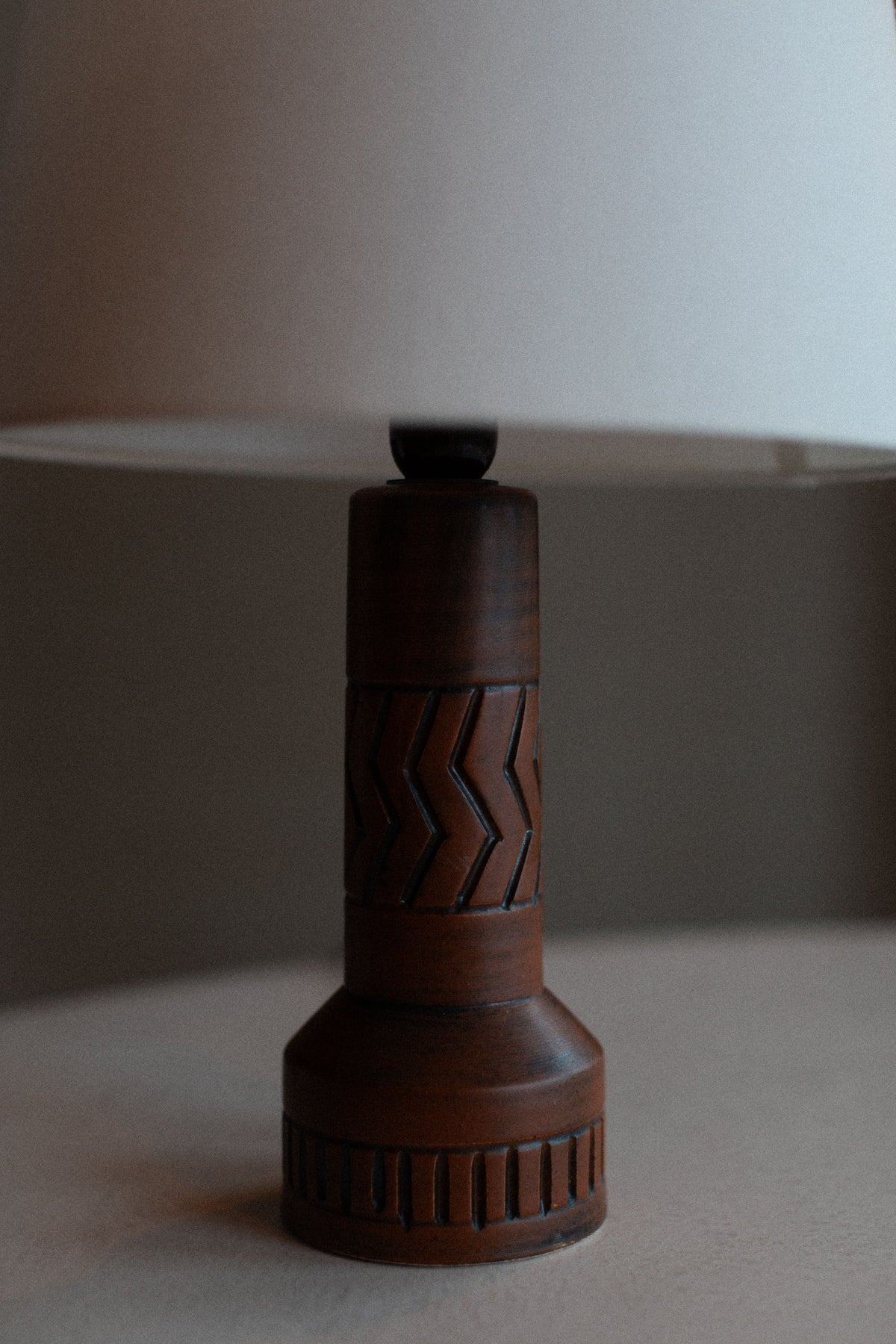 Vintage stoneware lamp with earthy tones and textured finish 