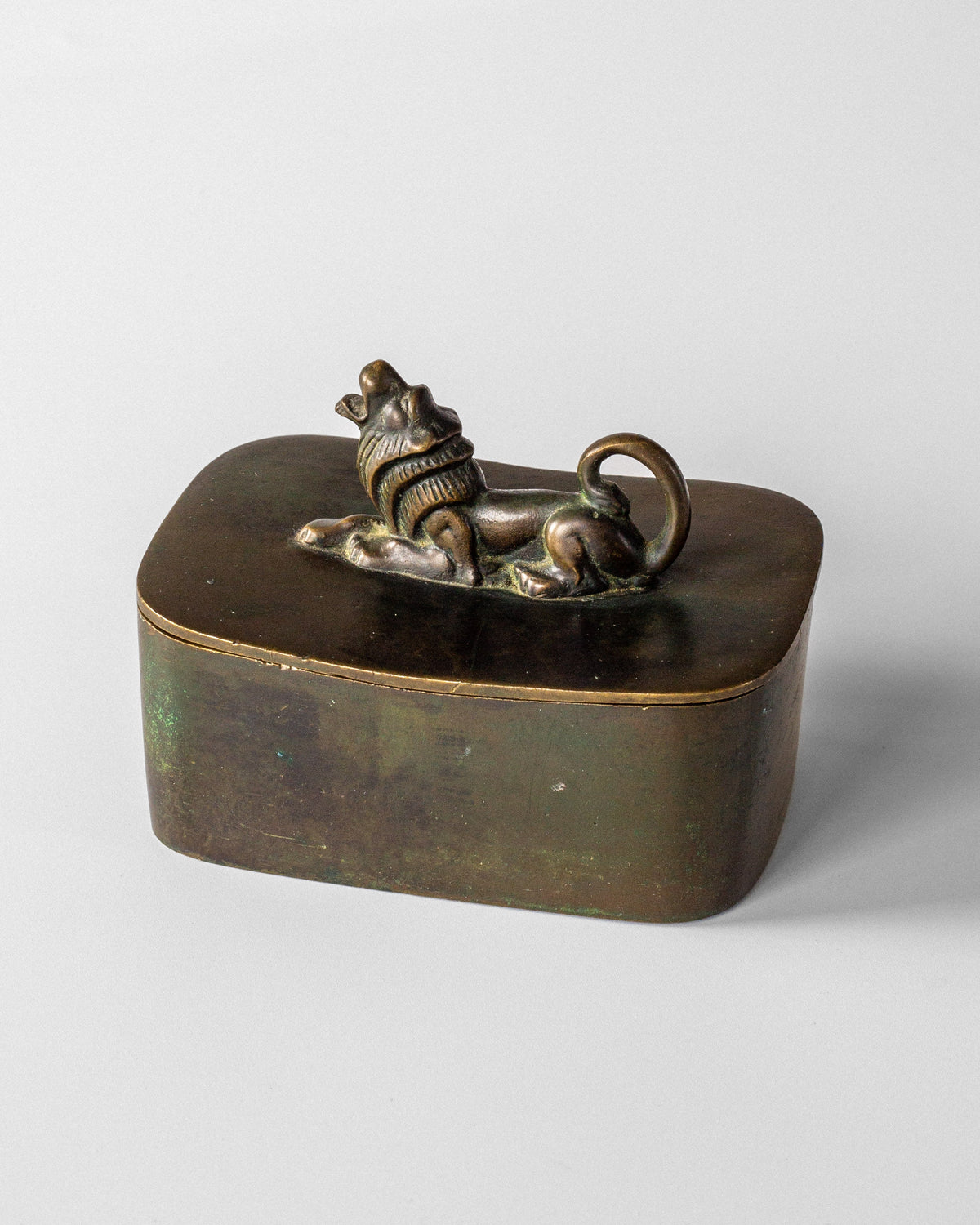 Bronze Art Deco box with reclining lion finial on oval lid