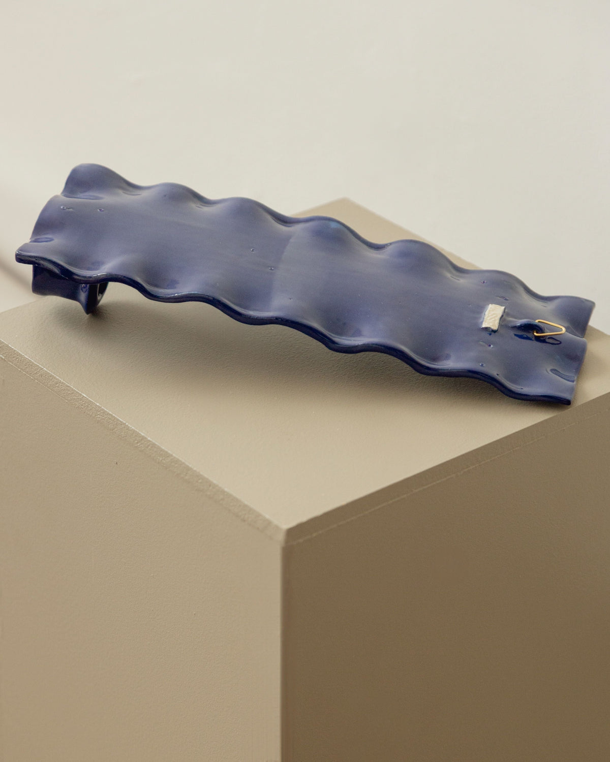 Blue glazed ceramic candle sconce with wavy organic form
