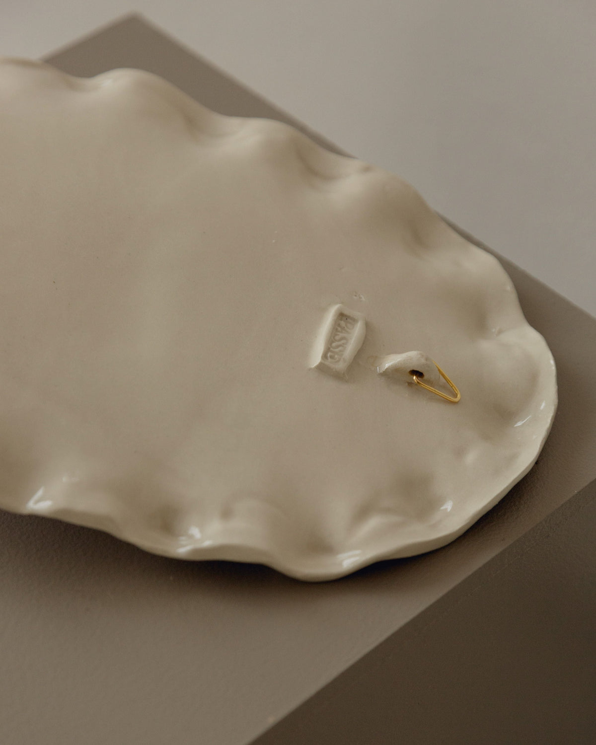Oval ceramic candle sconce in cream with gold accent detail