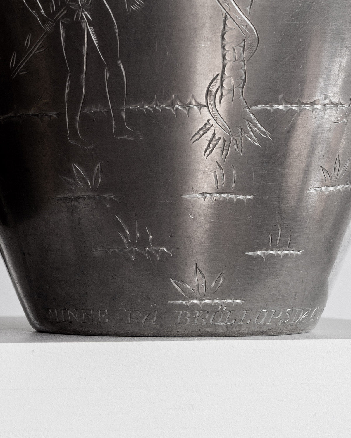 Detail of etched botanical motifs on Swedish pewter amphora base