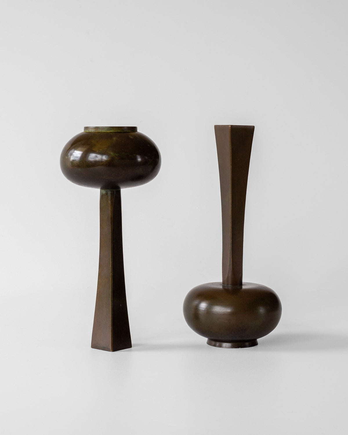 Two bronze Art Deco vases with spherical bodies and geometric stems