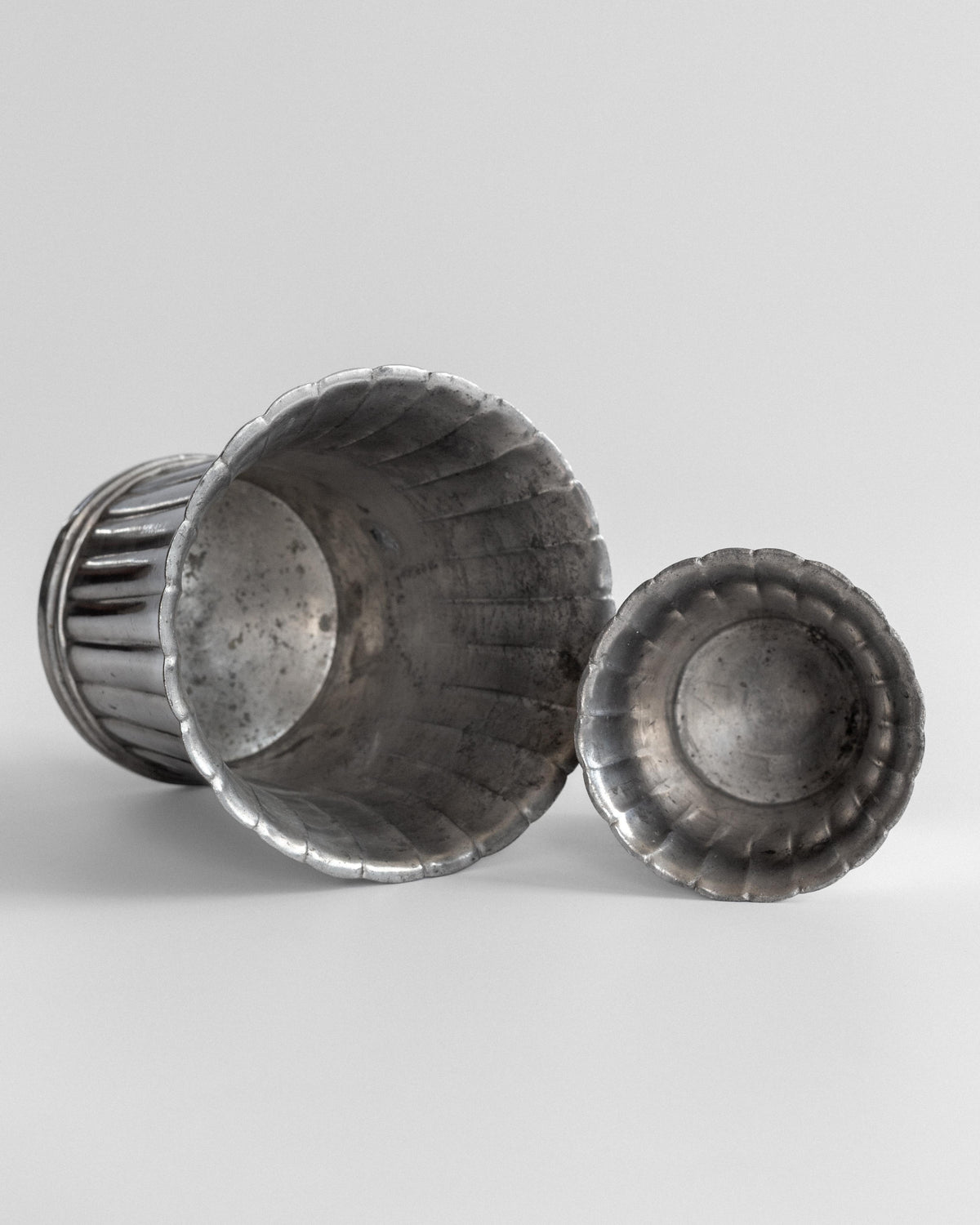 Fluted pewter vase set interior view showing ridged pattern detail