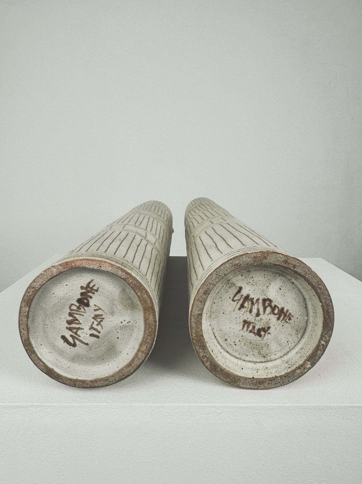 Bottom view showing maker's signatures on Bruno Gambone ceramic bottles