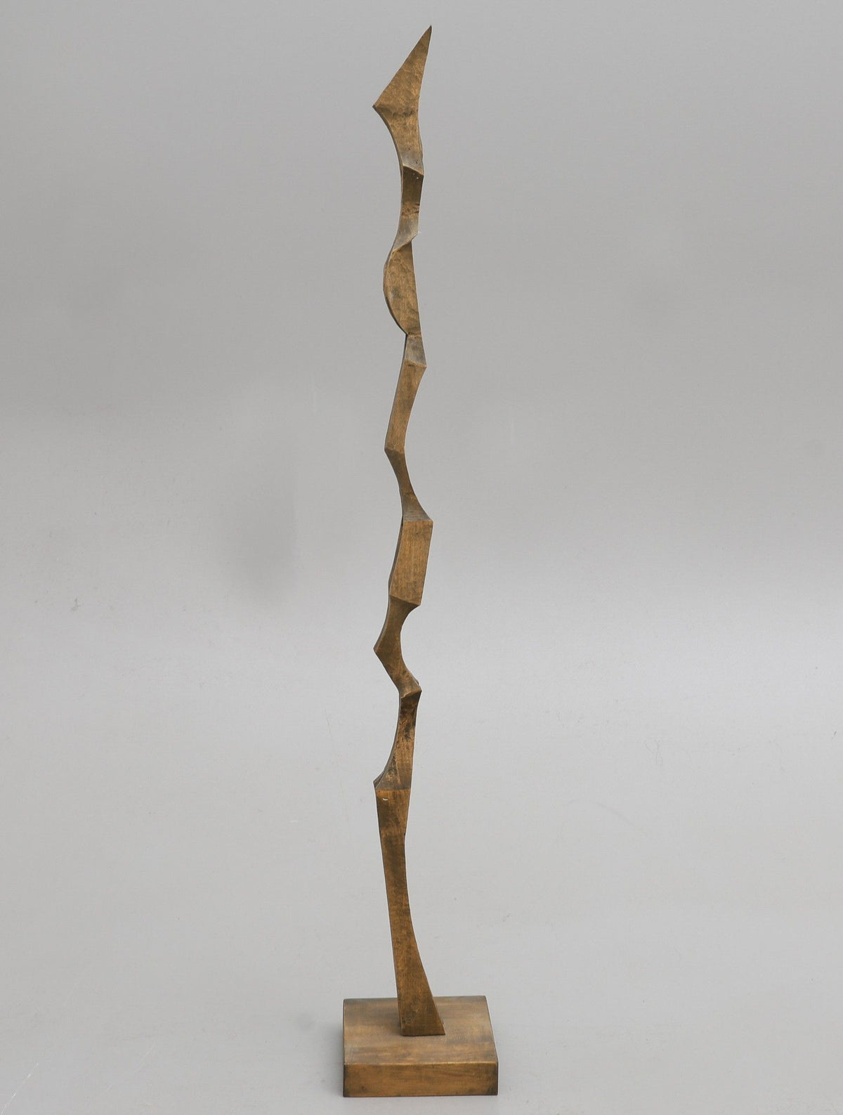 Tall biomorphic wooden sculpture with angular carved segments by Kristian Holmqvist