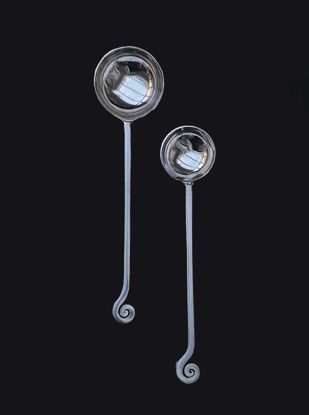 Stainless steel serving spoons with elegant spiral handles detail