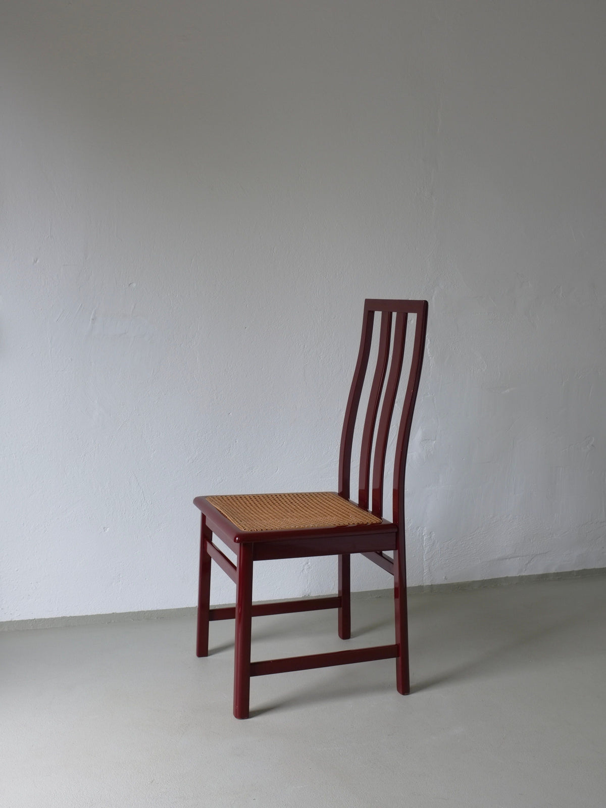 Single wine red cane seat chair with vertical slat back 1970s
