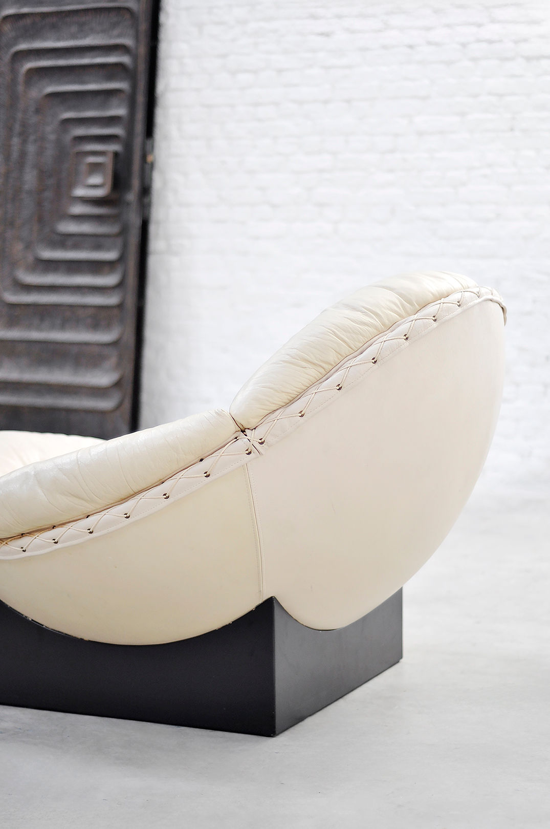 Detail view of Apollo lounge chair cream leather upholstery with studs