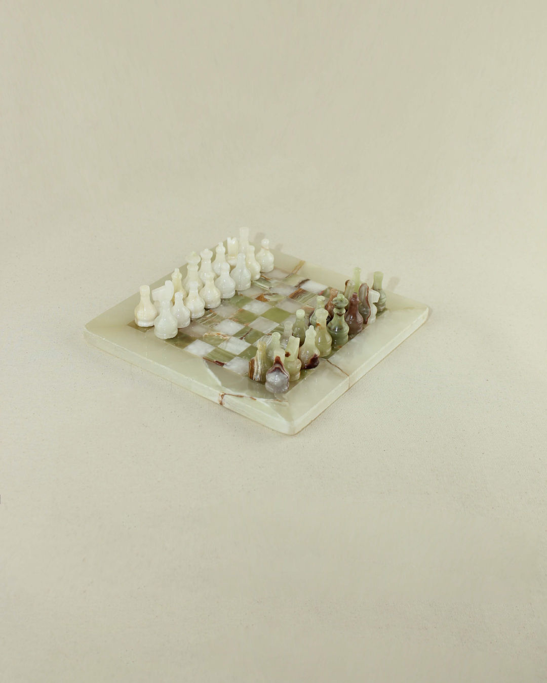 Luxurious onyx chess set with carved pieces on marble board