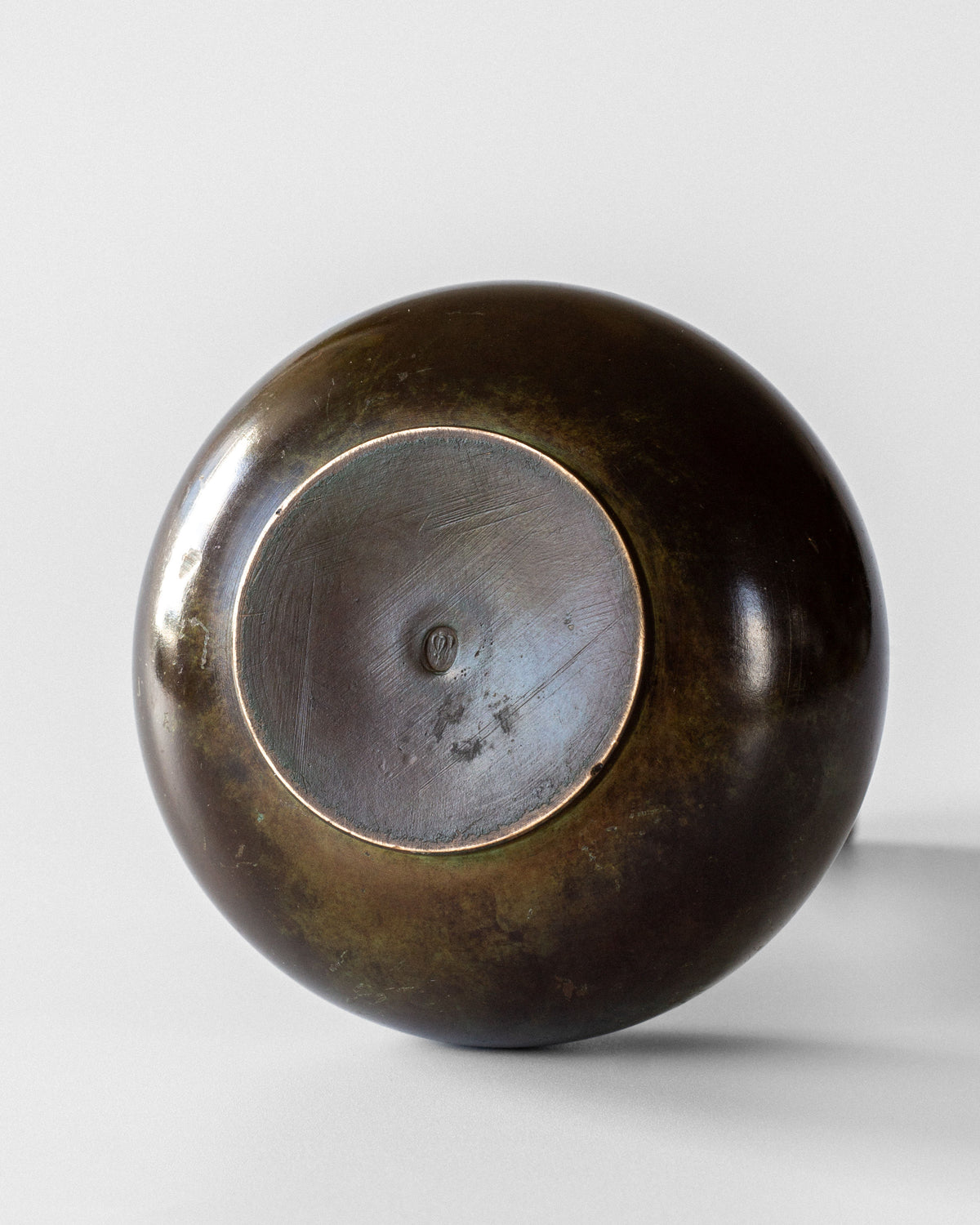 Bottom view of Art Deco bronze vase showing circular base detail
