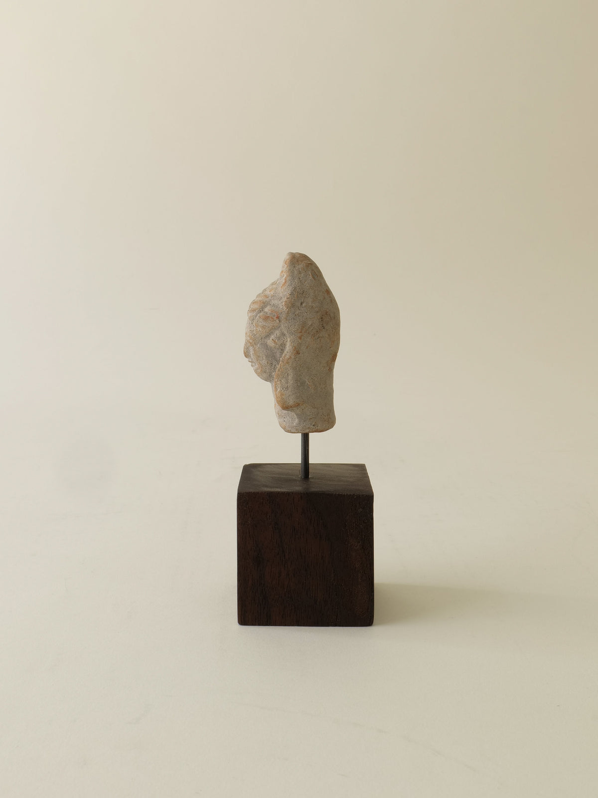 Ancient stone Hera sculpture head mounted on dark wooden base