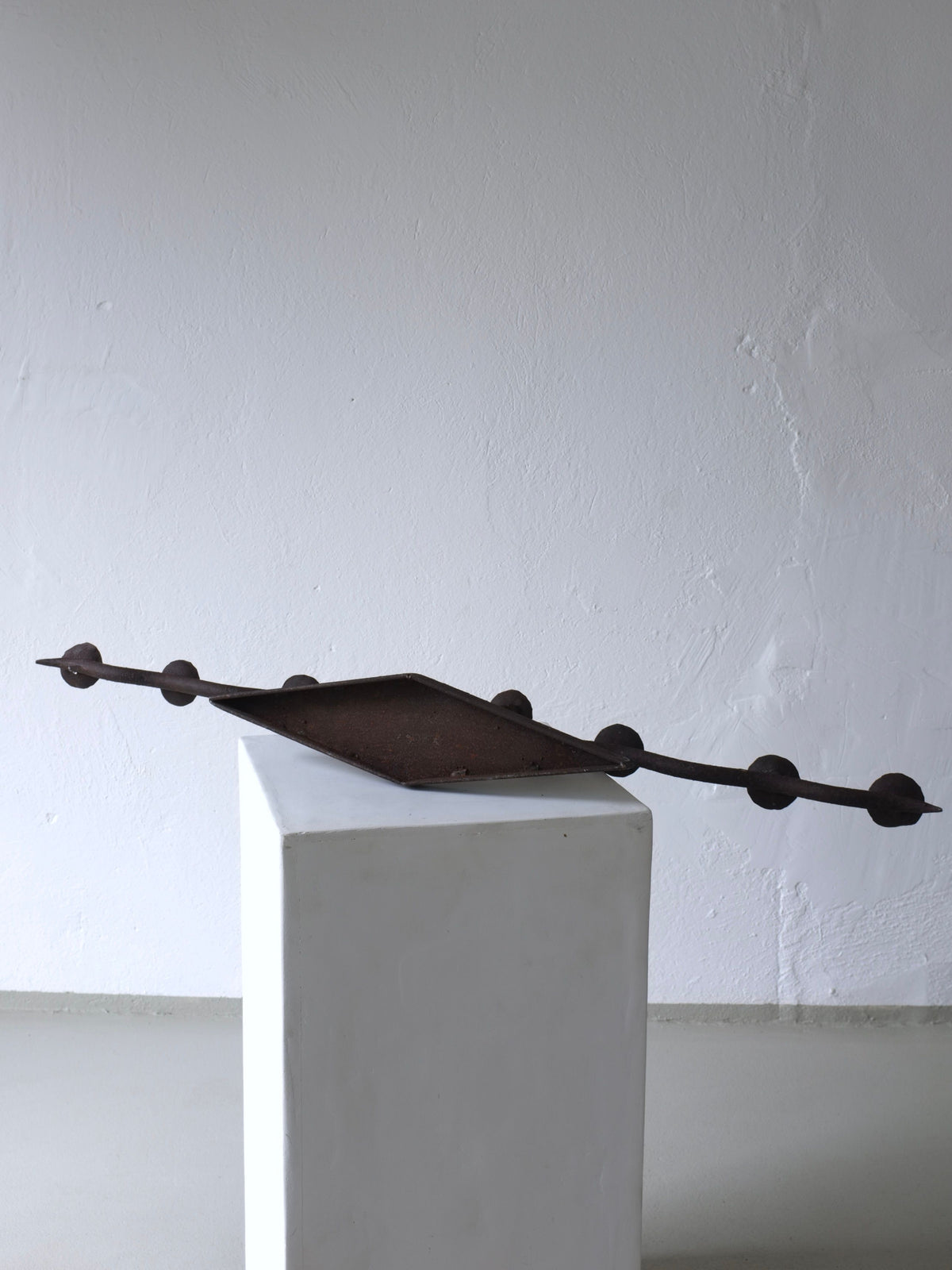 Large brutalist wrought iron candelabra display angle on pedestal