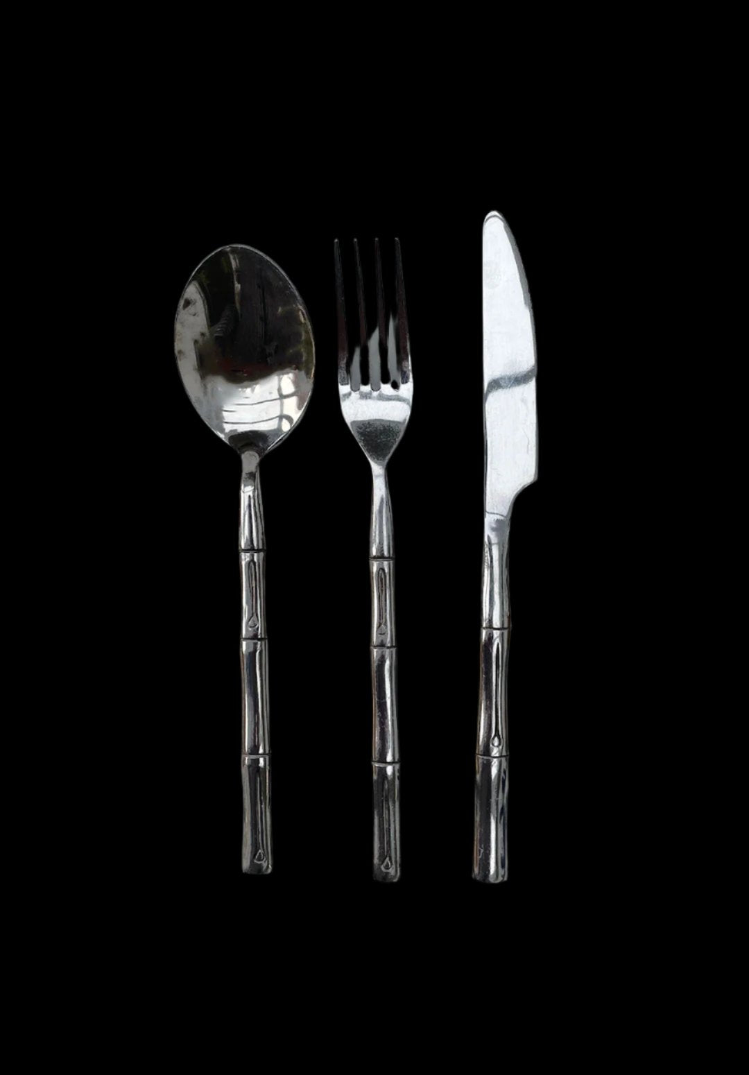 The Les Objoies Set of Bamboo Cutlery includes three stainless steel utensils—a spoon, a fork, and a knife—each with handles designed to resemble bamboo, presented against a black background.