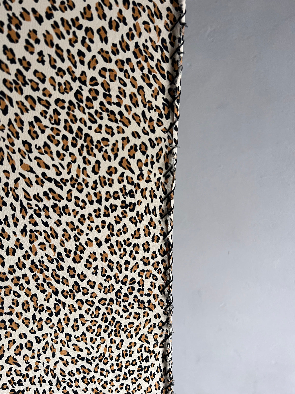 The Veter Vintage "Leopard Print Floor Lamp, 1980s" features a brown, black, and beige leopard print pattern beside a plain light gray wall and a vintage base.