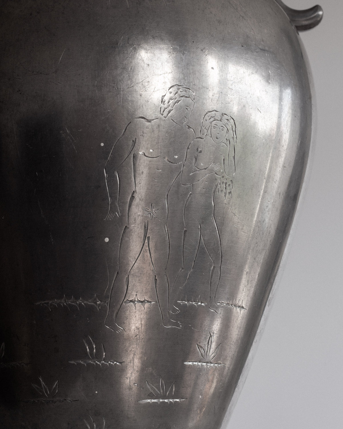Engraved Adam and Eve detail on Swedish Art Deco pewter amphora