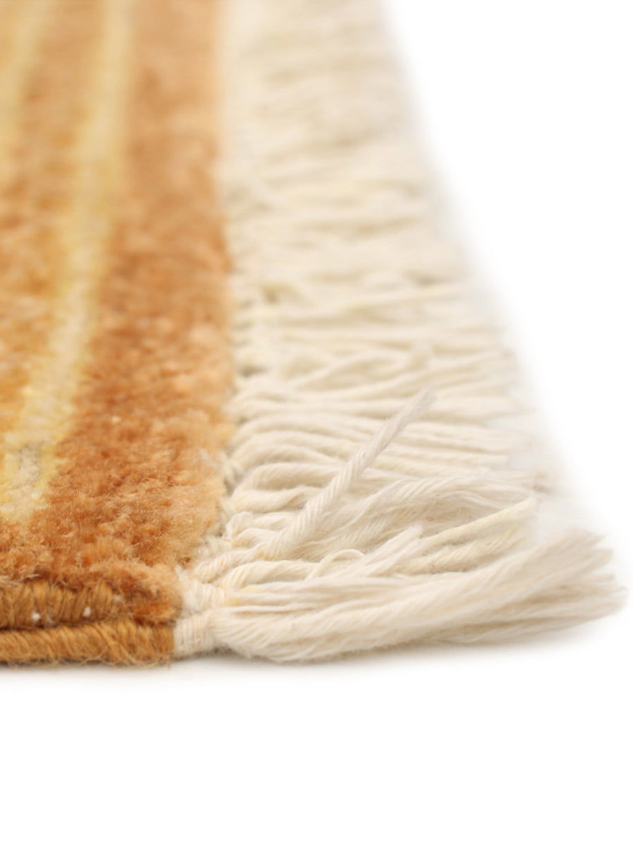 Close-up of the edge of the catalog:three Chobi Rug in Ardor (239 x 292 cm) with yellow and brown tones and thick cream fringe, set against a white background.