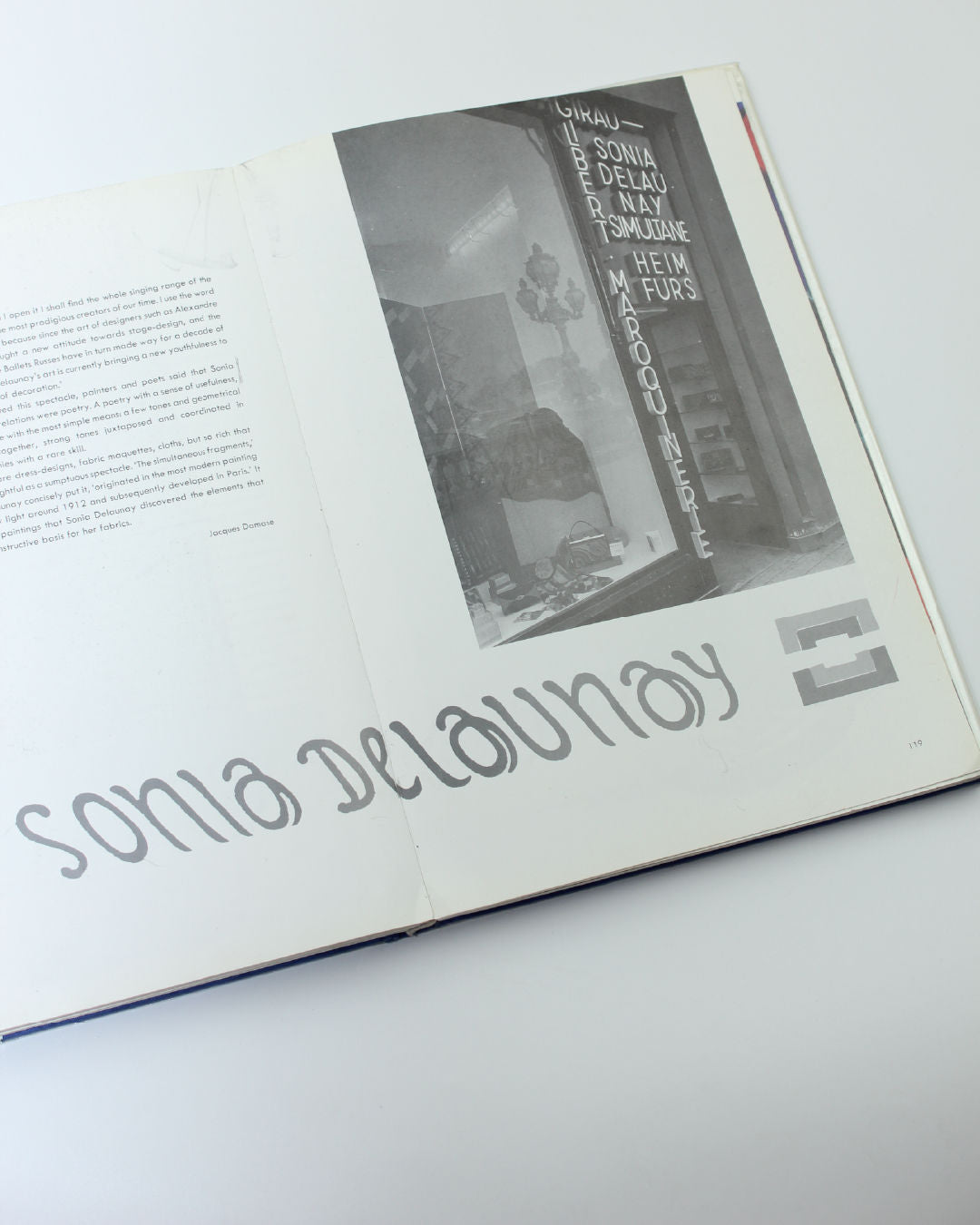 Sonia Delaunay fashion and fabrics book open spread showing storefront