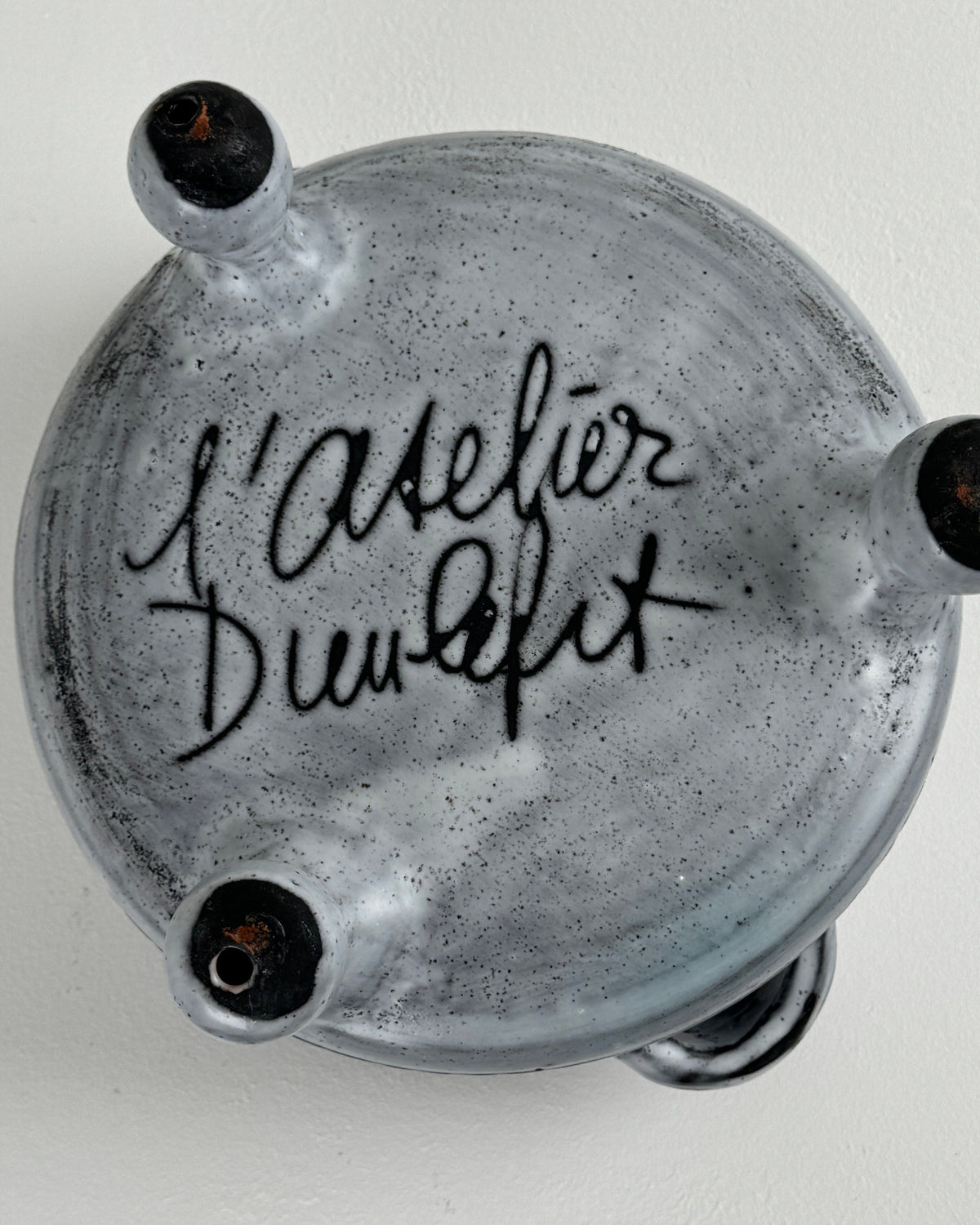 Bottom view of speckled ceramic tureen showing Jacques Pouchain signature