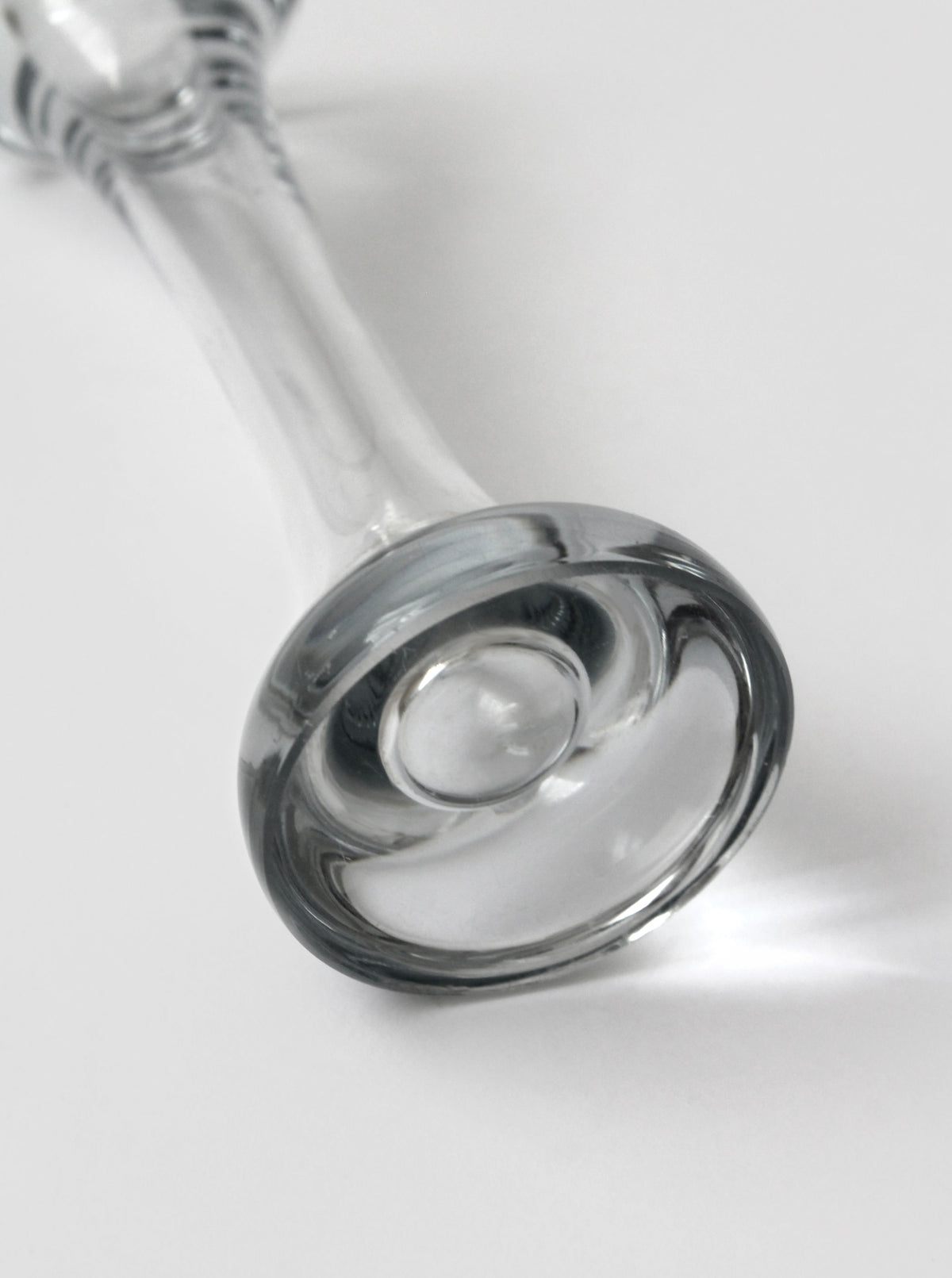 Close-up detail of vintage 60s glass solifleur vase base showing curved form