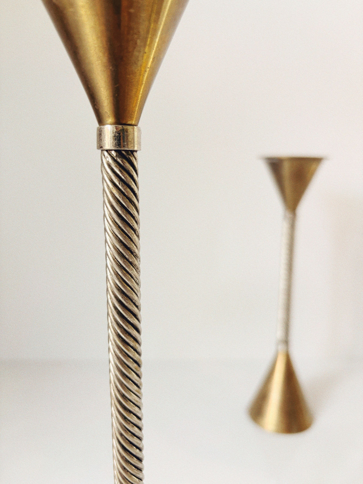 Twisted brass candlestick holder with conical top detail view
