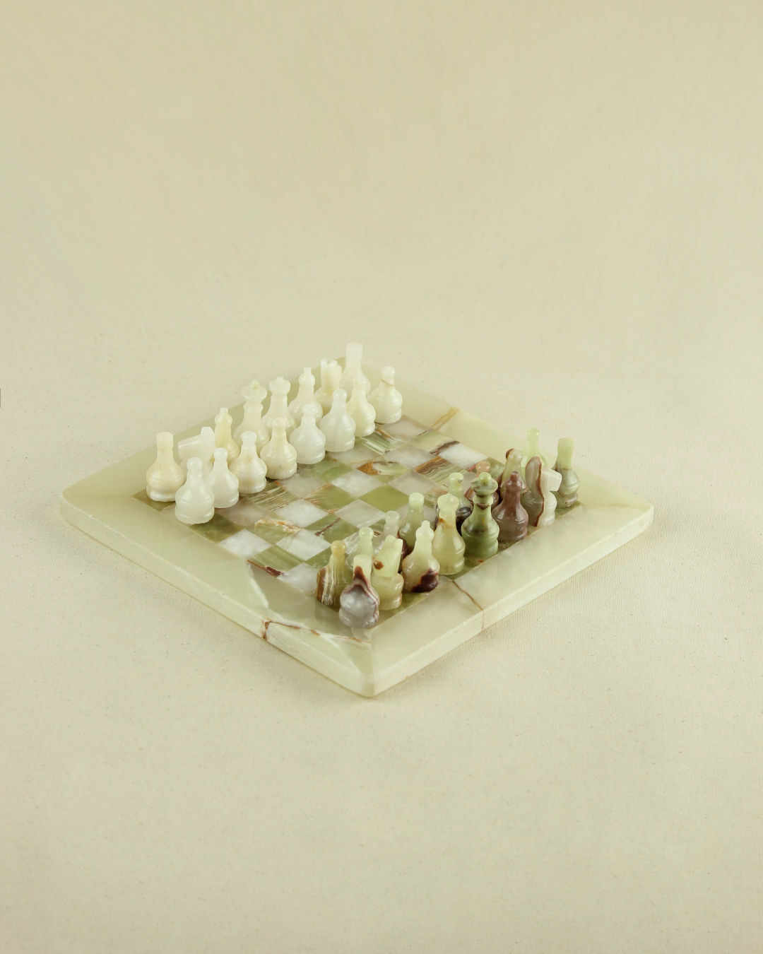 Elegant onyx chess set with green marble board and carved pieces