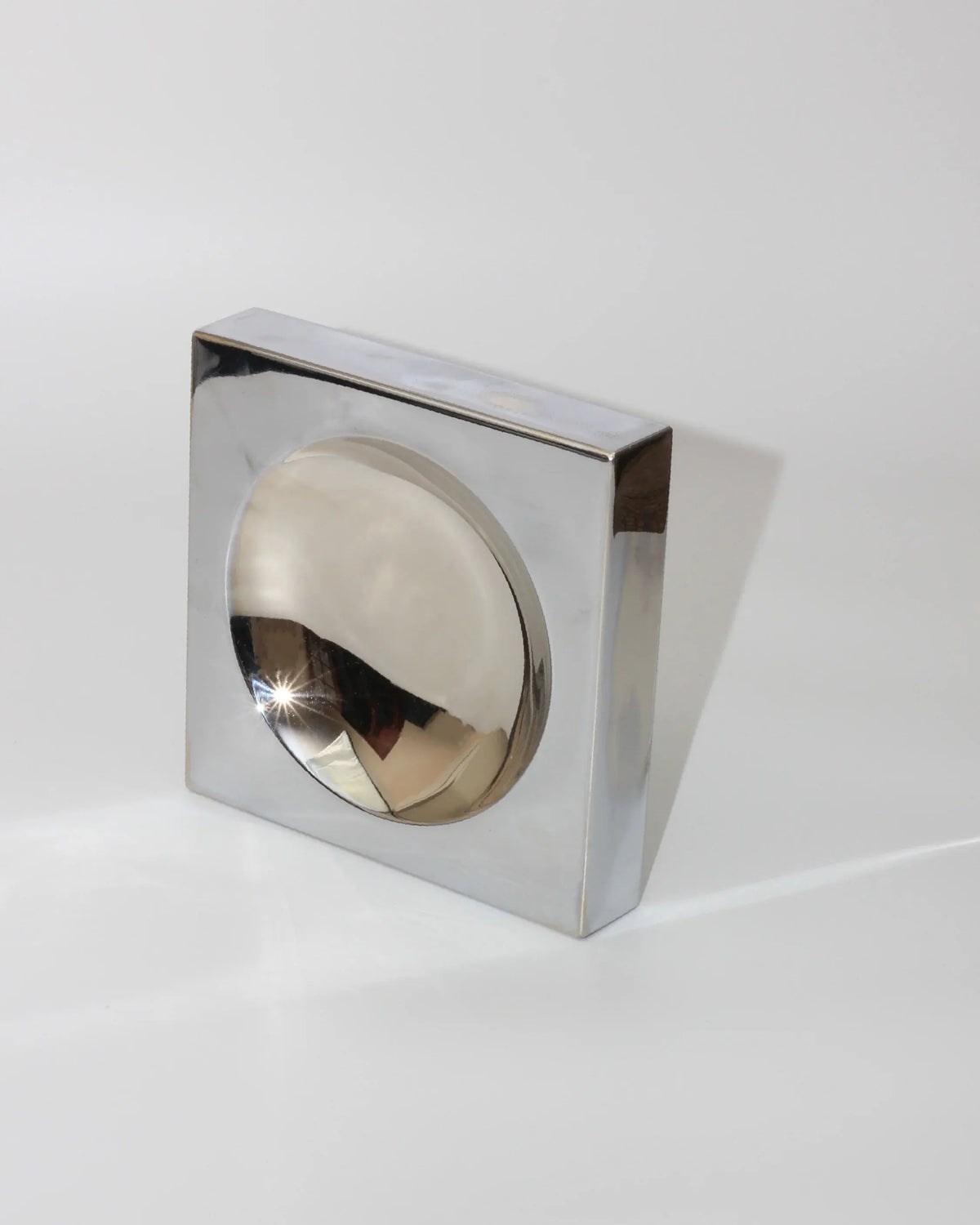 Chrome sculptural vide-poche with circular brass bowl insert