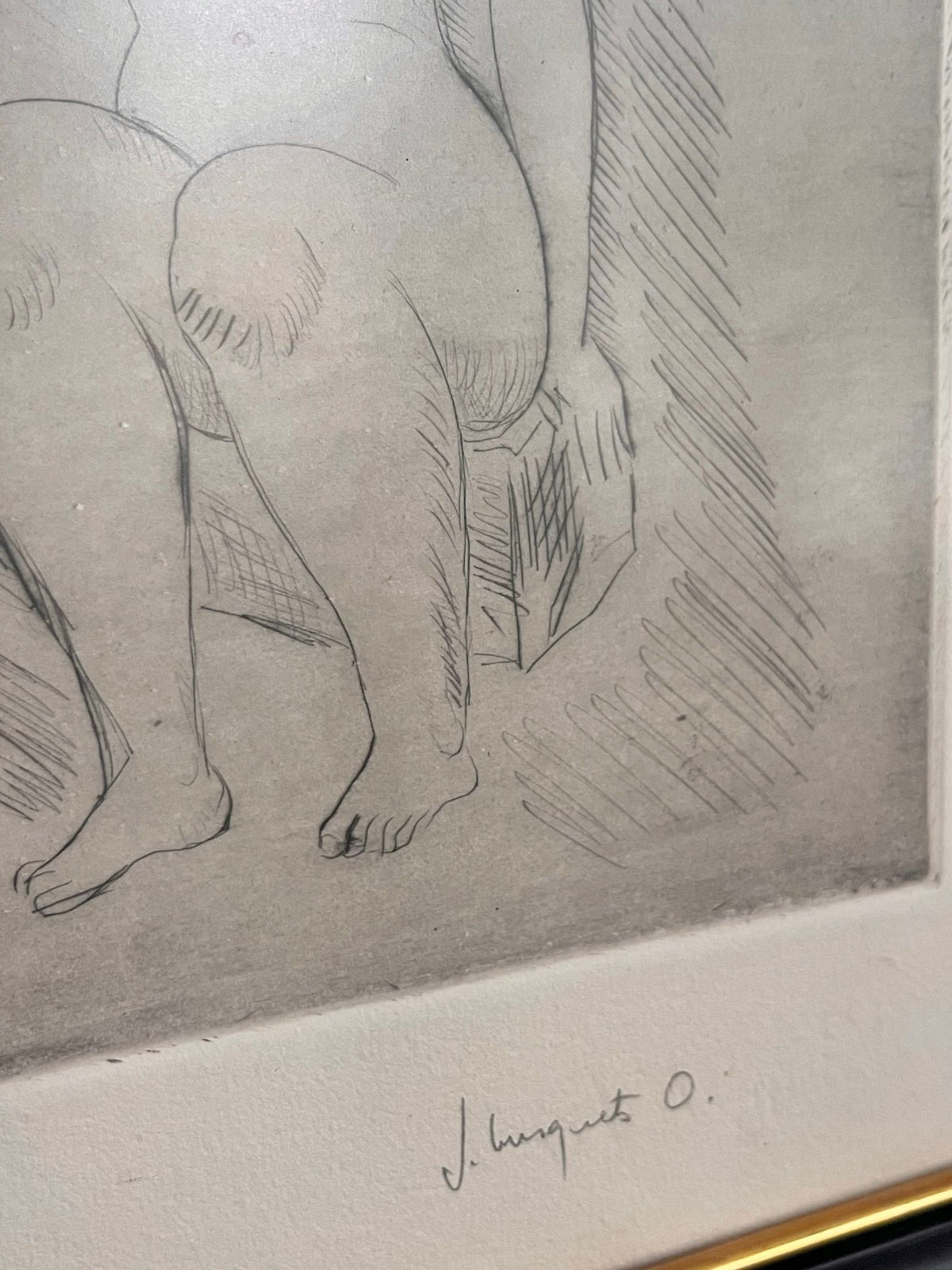 The "Bathers" drawing by Josep Busquets Odena, presented under the Médecine brand, features an intricate etching of a seated individual with emphasis on the legs and partial torso. The figure is situated on a textured surface evocative of a Spanish sculptor's style. The artist's signature, "J. August O.," is gracefully displayed in the bottom right corner.