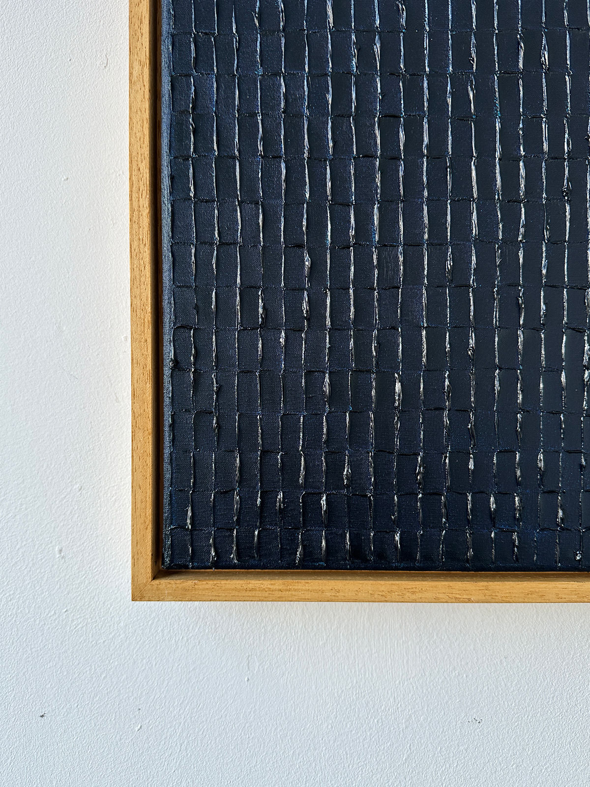 Close-up detail of Prussian Blue textured paint grid pattern by Roi Elmaliah