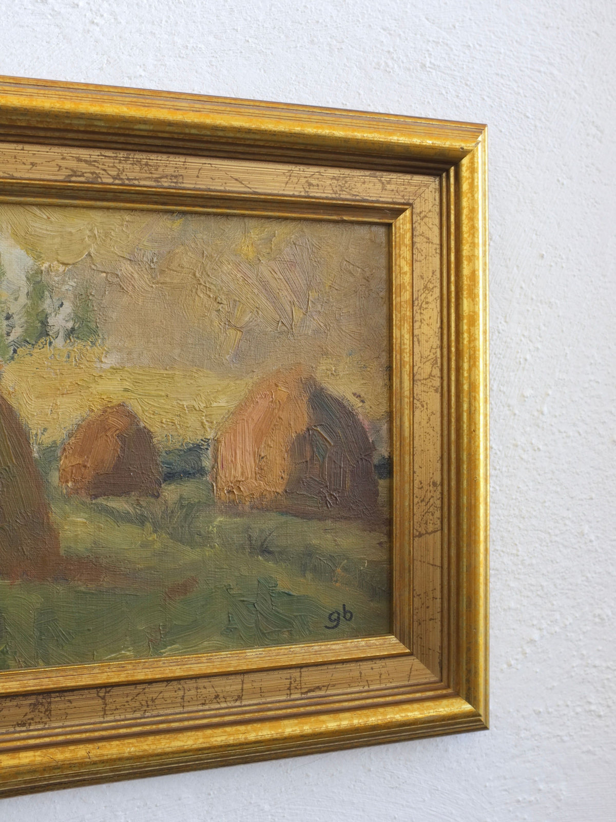 Ornate gold frame detail of 1950s haystack landscape painting