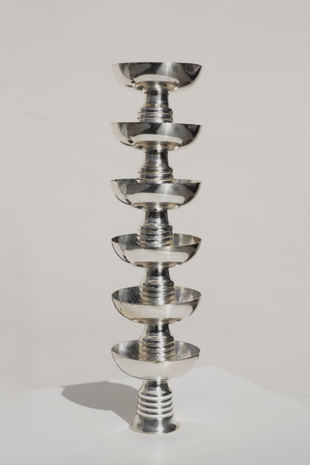 Stacked silver ice coupes showing tiered serveware design
