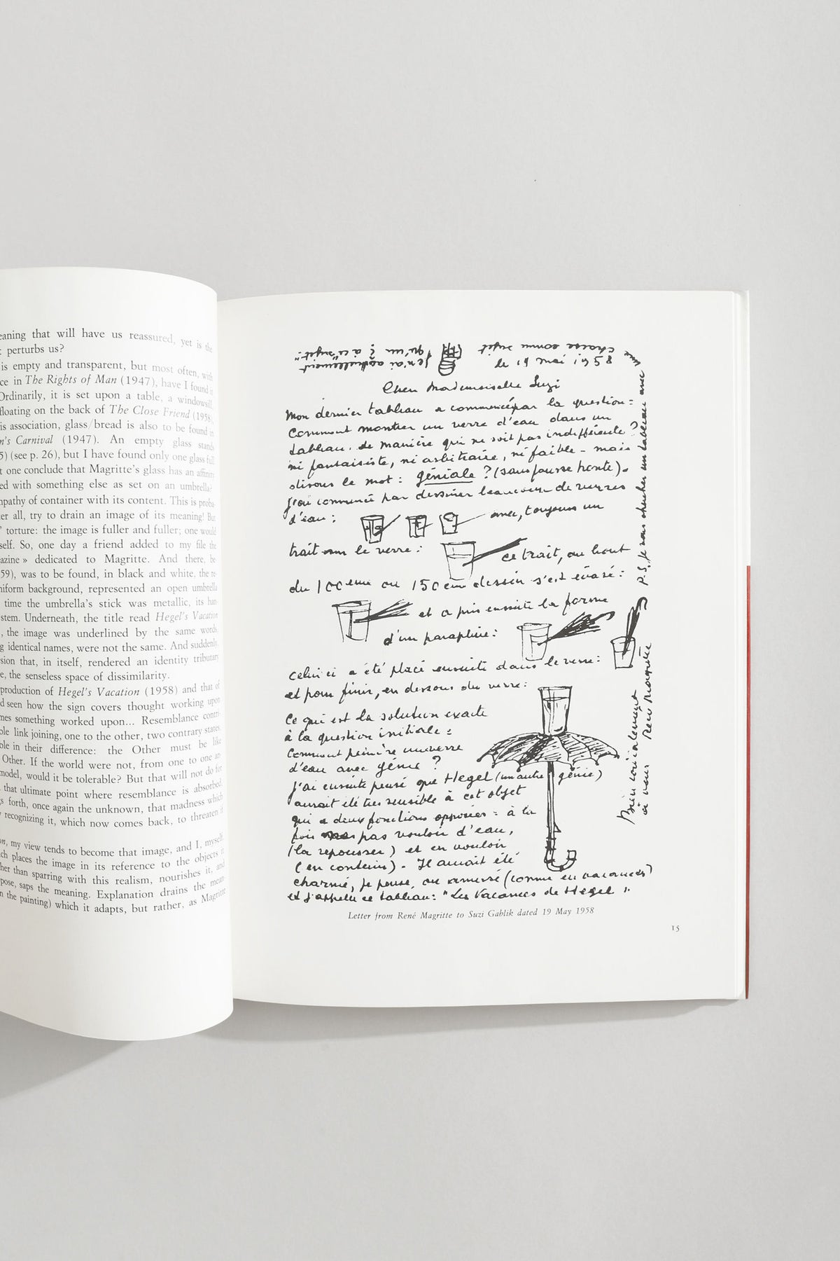 Open Magritte art book showing handwritten letter with sketches