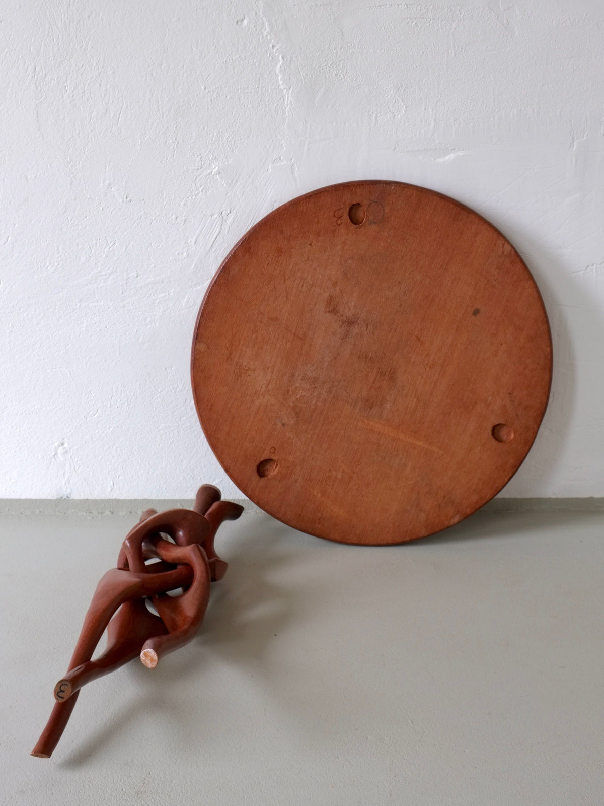 Underside view of sculptural carved teak side table from 1960s