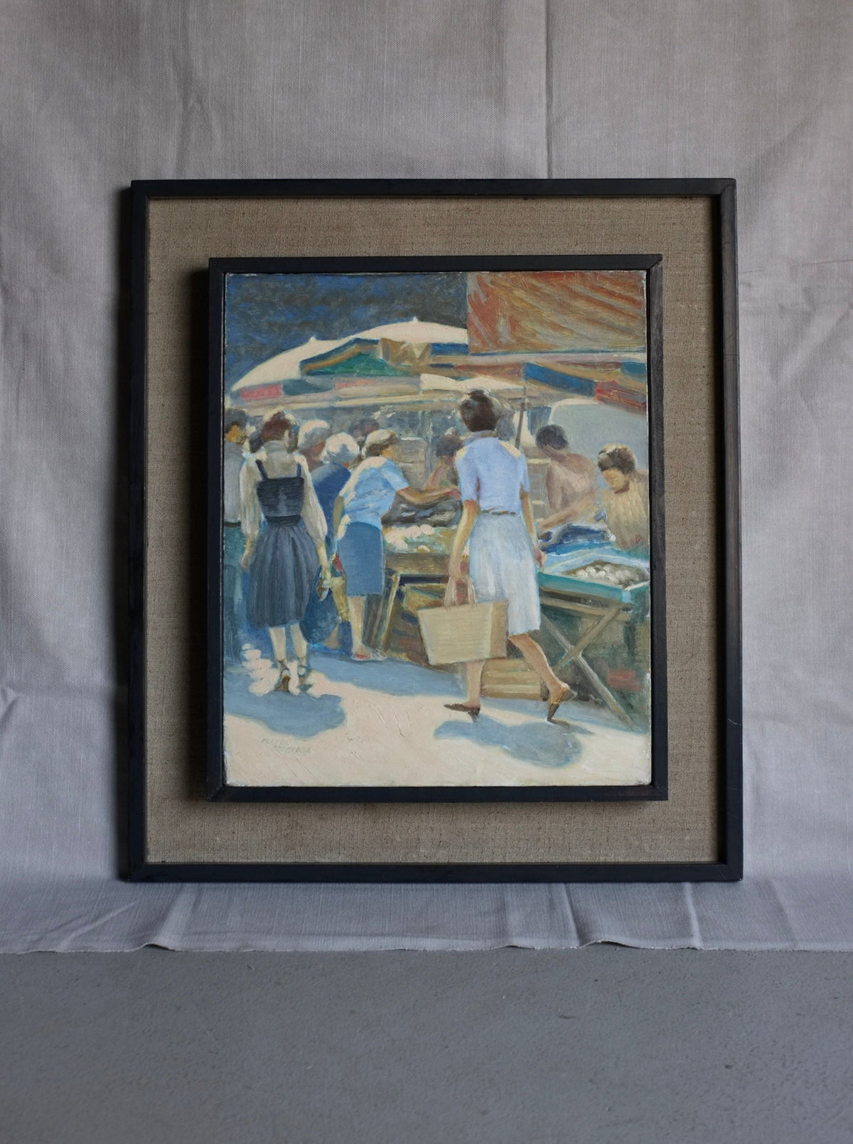 The "Vintage Genre Oil Painting with Market Scenes" by Veter Vintage, framed elegantly, captures a vibrant summer market day. The Spanish artist portrays people interacting energetically against a backdrop of colorful market stalls and umbrellas. The figures are depicted in mid-action, infusing the scene with lively dynamism, while the frame rests against a textured backdrop.