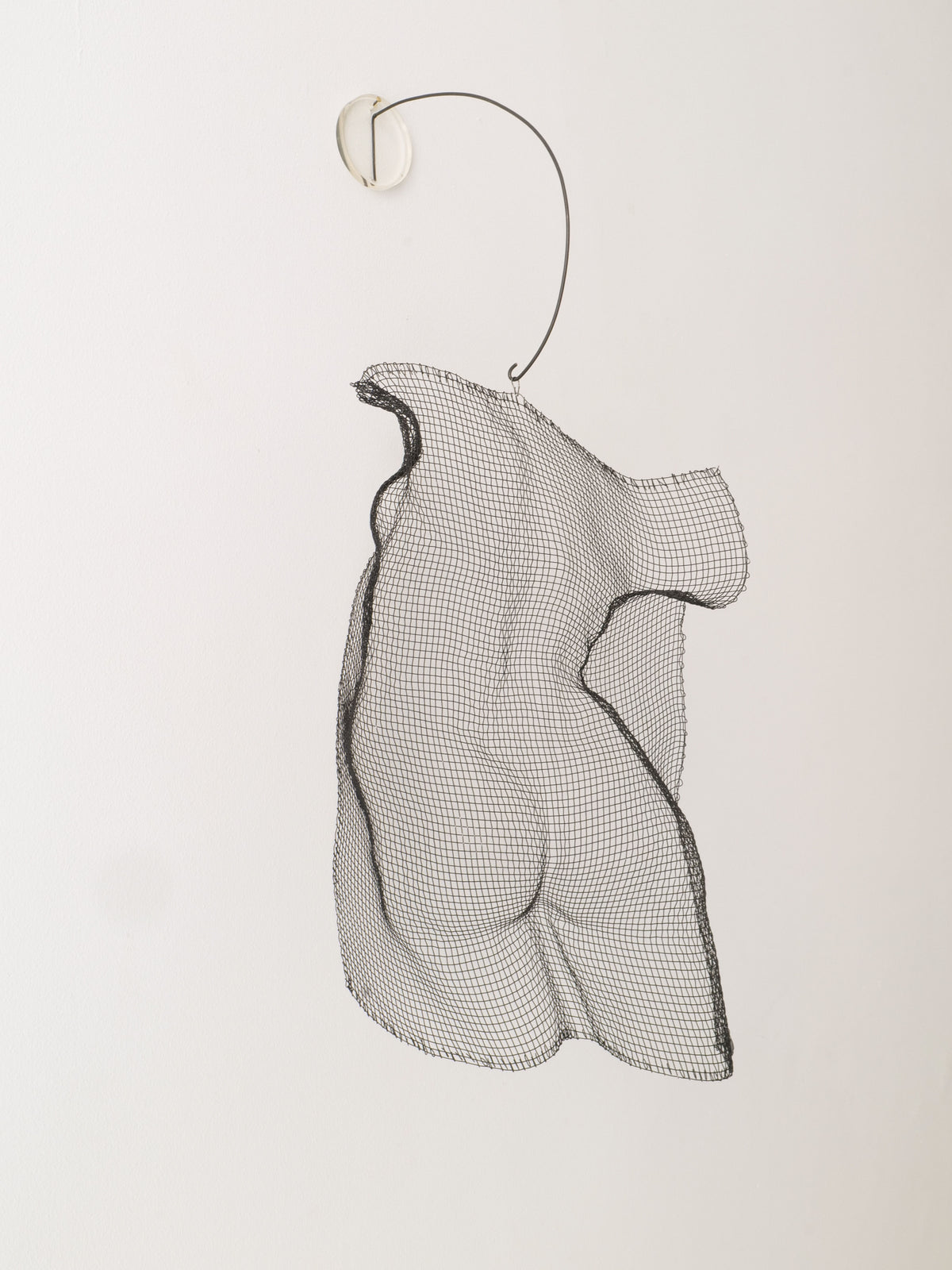 The 'Turning Torso' Wall Sculpture by Collection apart is a Swedish-style copper mesh piece hanging from a thin, curved wire, expertly shaped to form a human torso that creates a striking 3D effect against any light background.