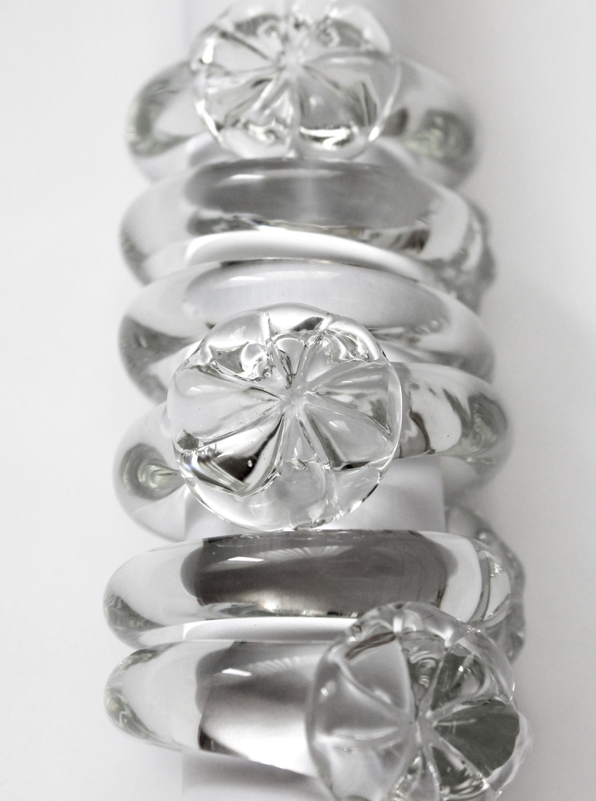 Set of vintage clear glass napkin rings with floral motifs