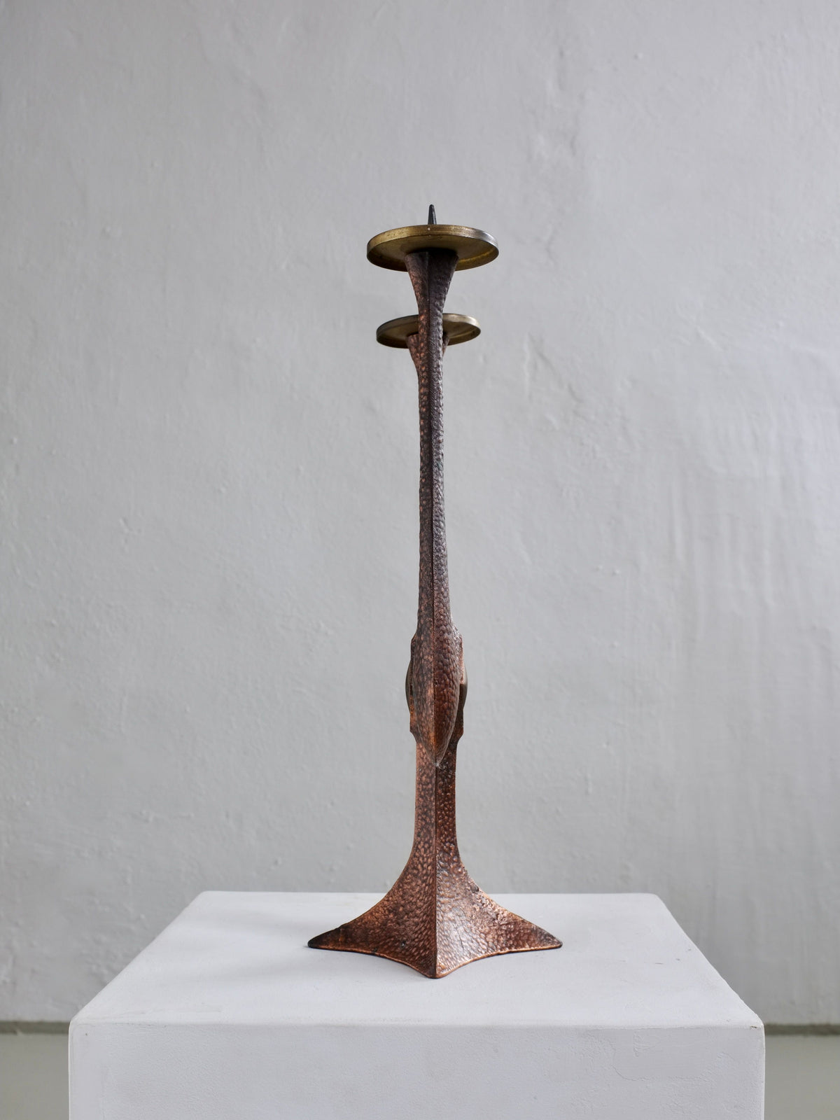 Brutalist copper candlestick with hammered texture and brass bobeches