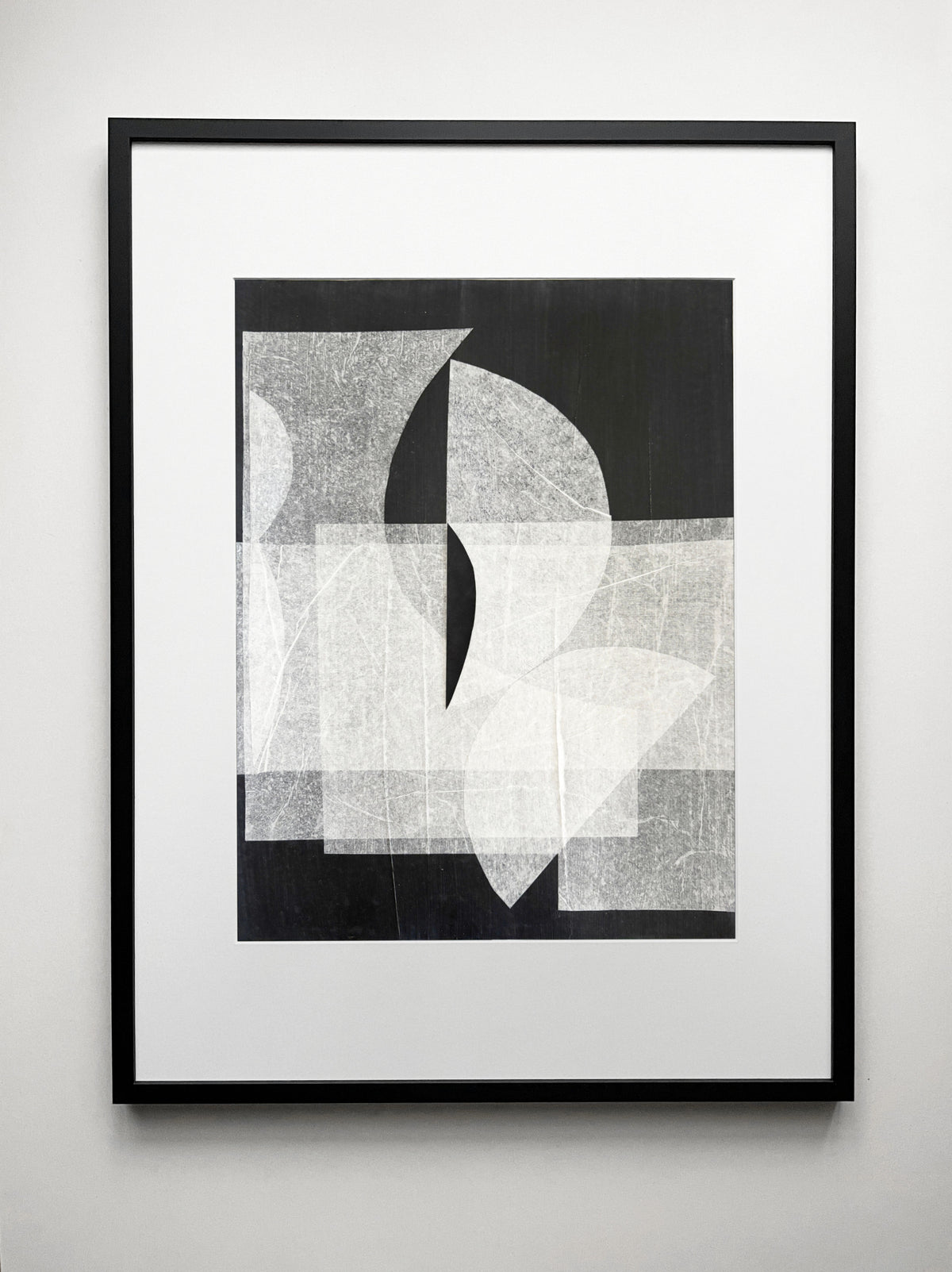 Abstract geometric drawing with overlapping white and gray shapes on black background