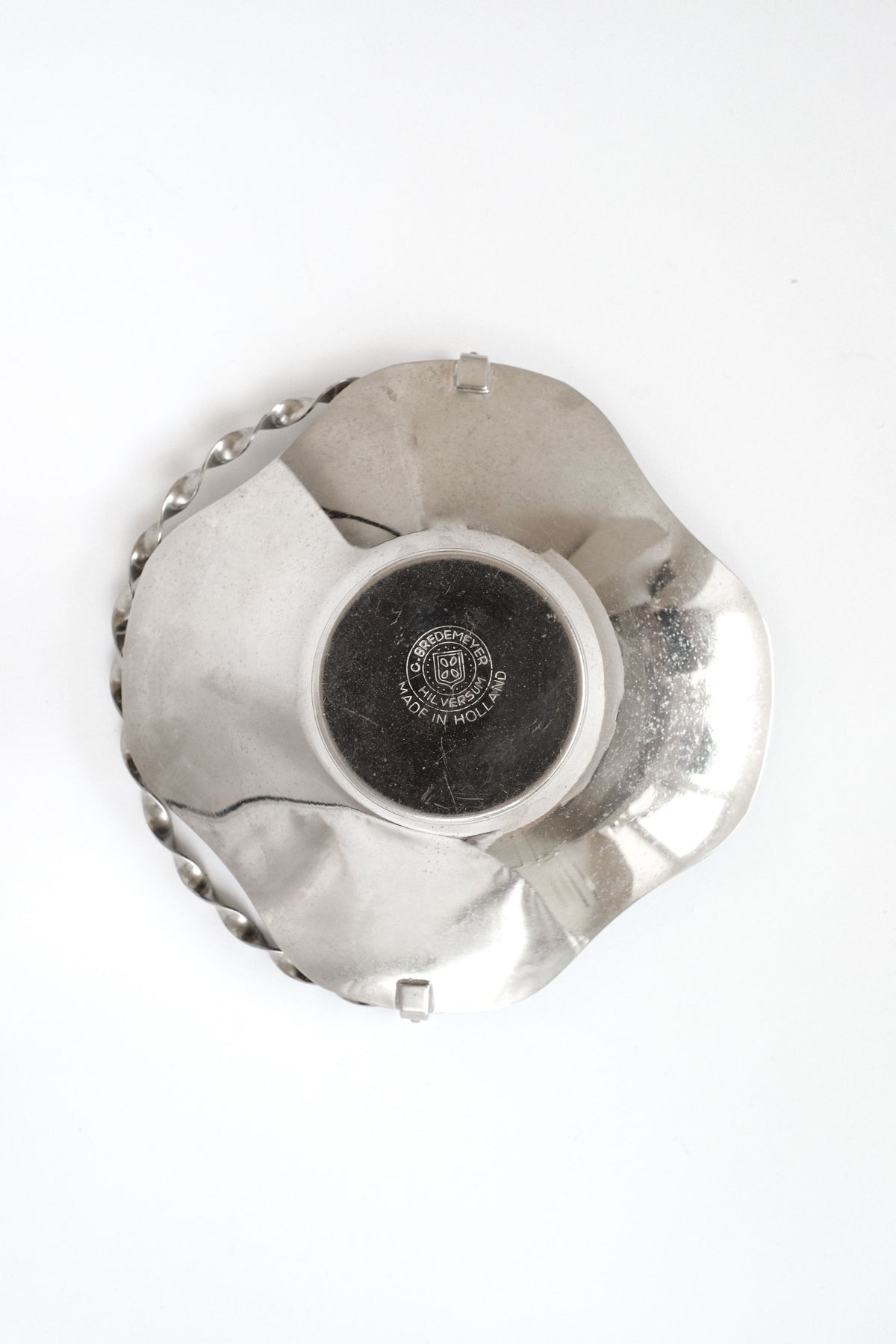 Bottom view of small twisted handle glass decorative basket