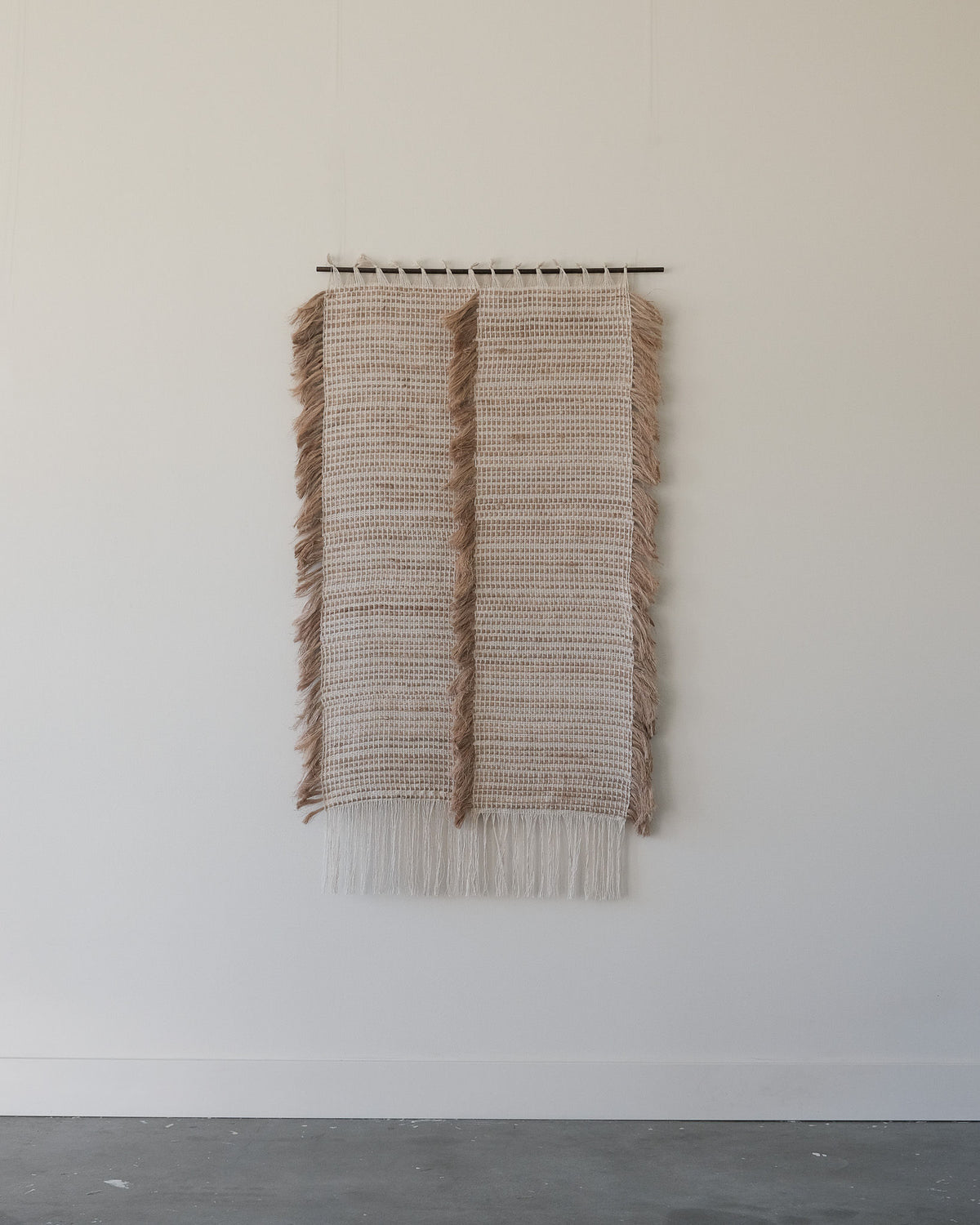 Ripple woven wall sculpture with natural fibers and fringe