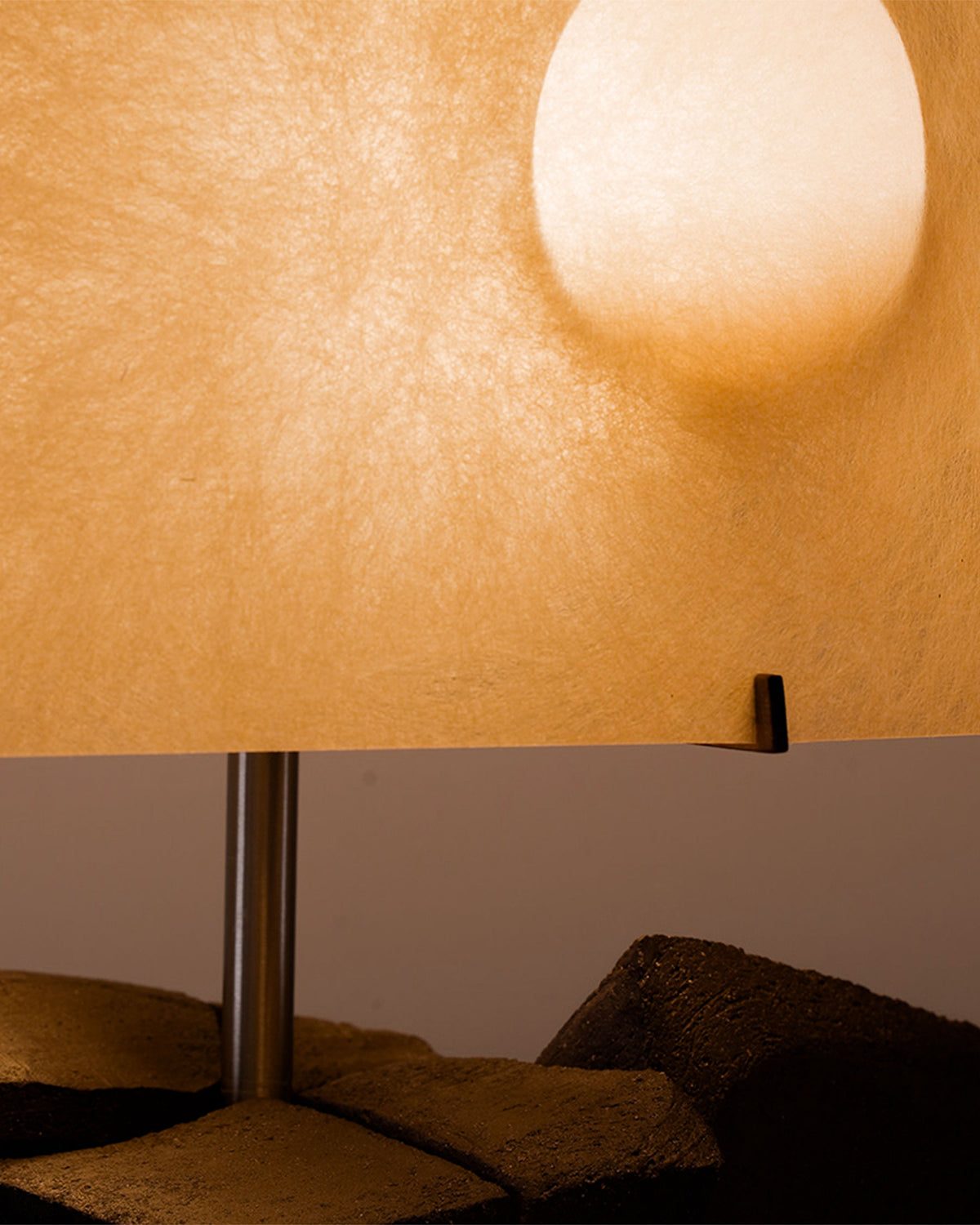 Sunrise table lamp warm ambient glow on textured wall detail