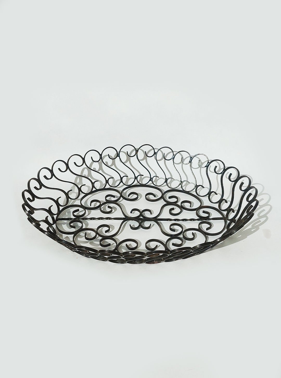 Ornate wrought iron serving basket with scrollwork pattern, 1950s