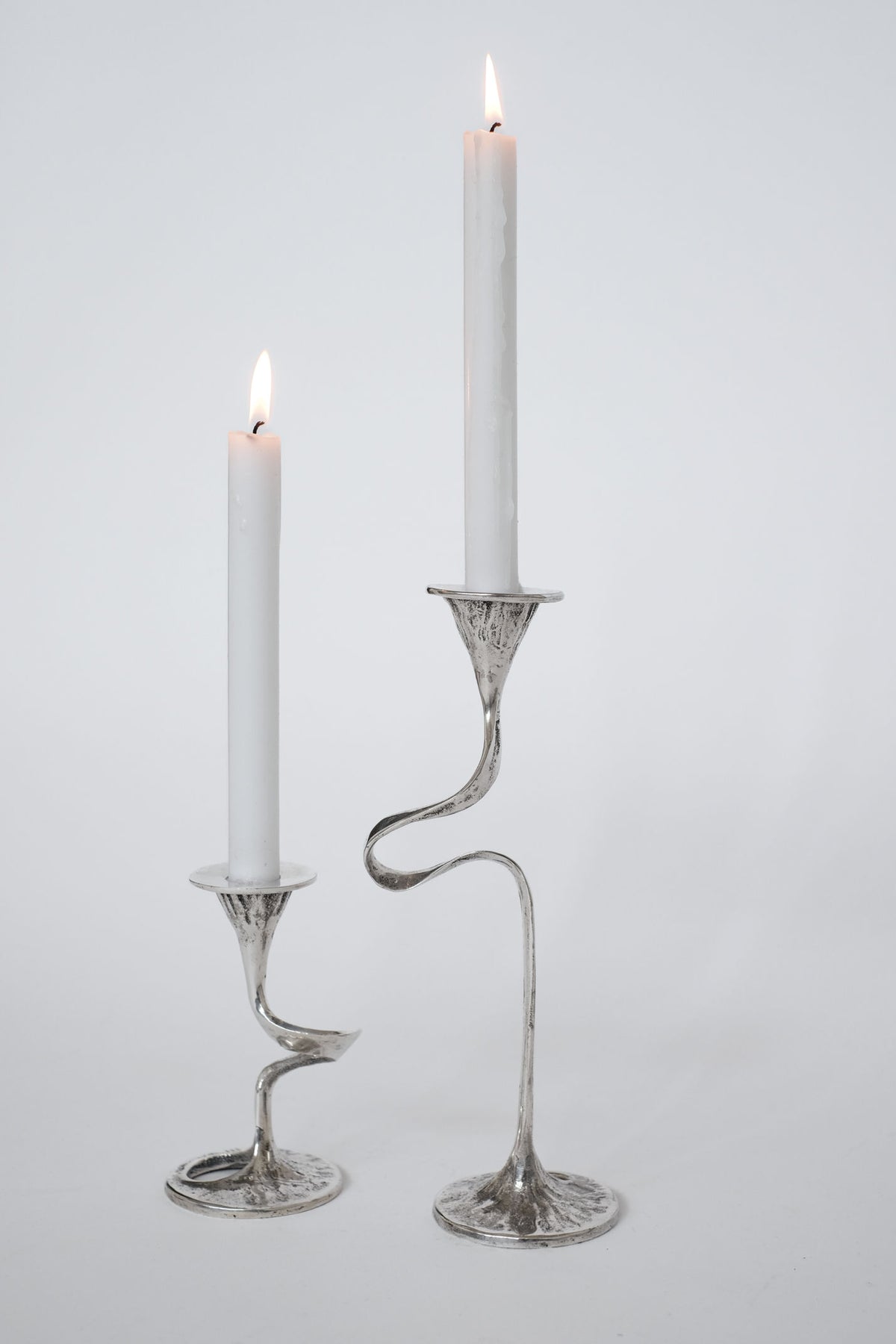 Silver-plated twisted stem candle holders with lit white candles