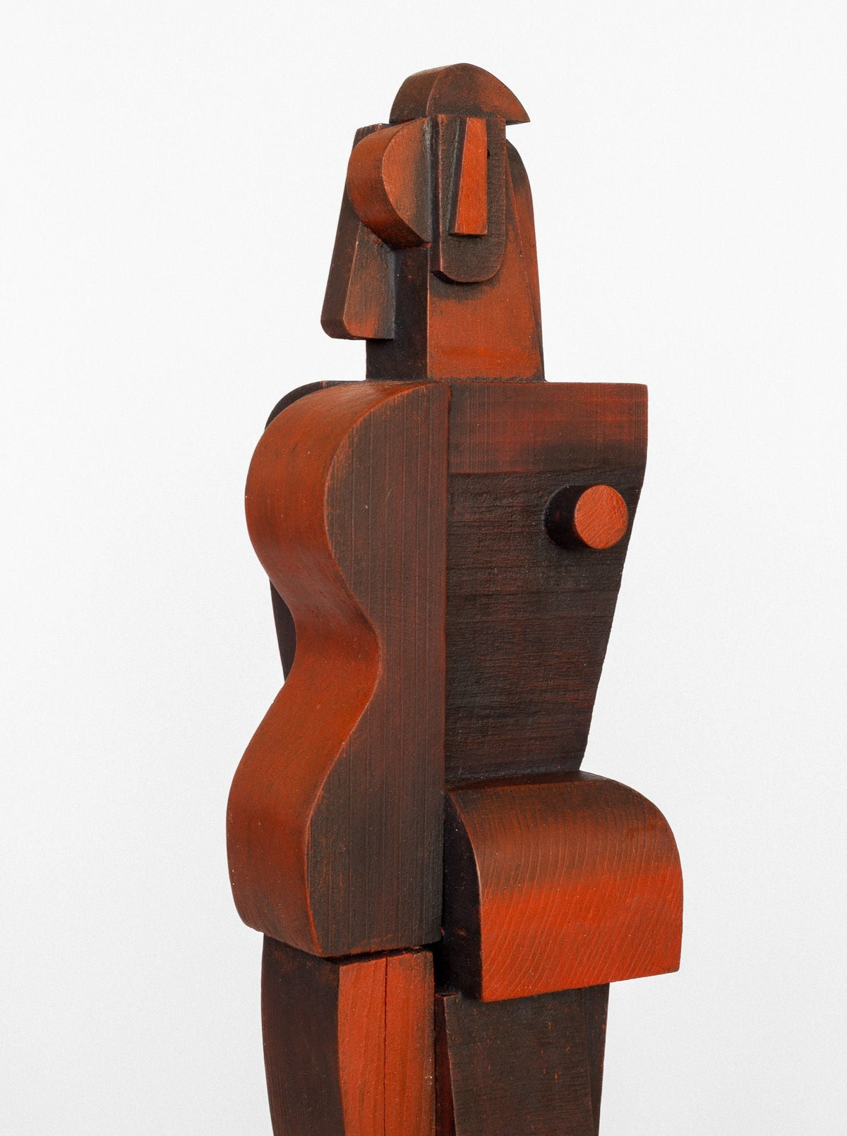The Cubist Sculpture by Spigel is an abstract human figure crafted from wood, featuring geometric shapes and lines. The piece boasts a dark and reddish-brown finish with striking curves and angles, embodying a stylized minimalist design inspired by cubism. The figure stands upright in a refined pose.