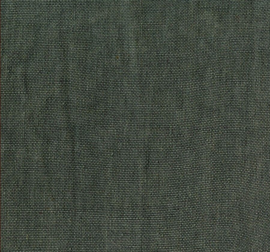 A close-up of the FORMA textured green linen fabric from FEBRERO SHOP, featuring a subtle weave pattern, drapes over an armchair. The surface displays a slightly coarse texture with interwoven dark and light green threads, creating a natural and earthy look.